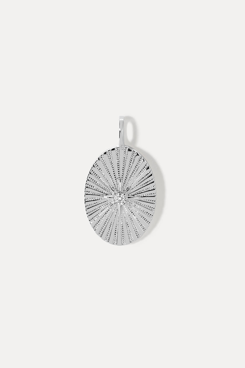 Silver oval Amanda Charm with a sunburst starburst pattern and a sparkling center stone on a white background.