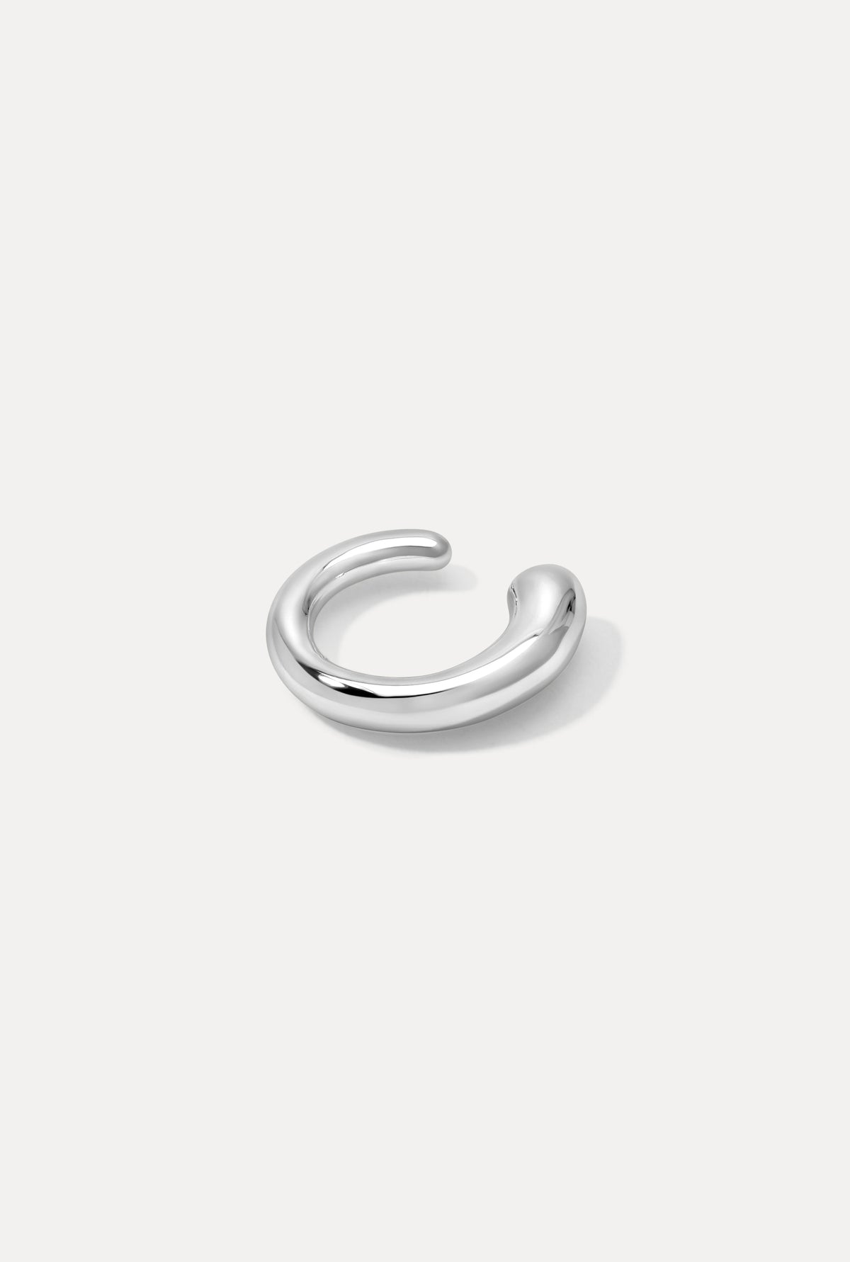 Silver Bella Ear Cuff with a smooth, thick curved silhouette on a plain white background.