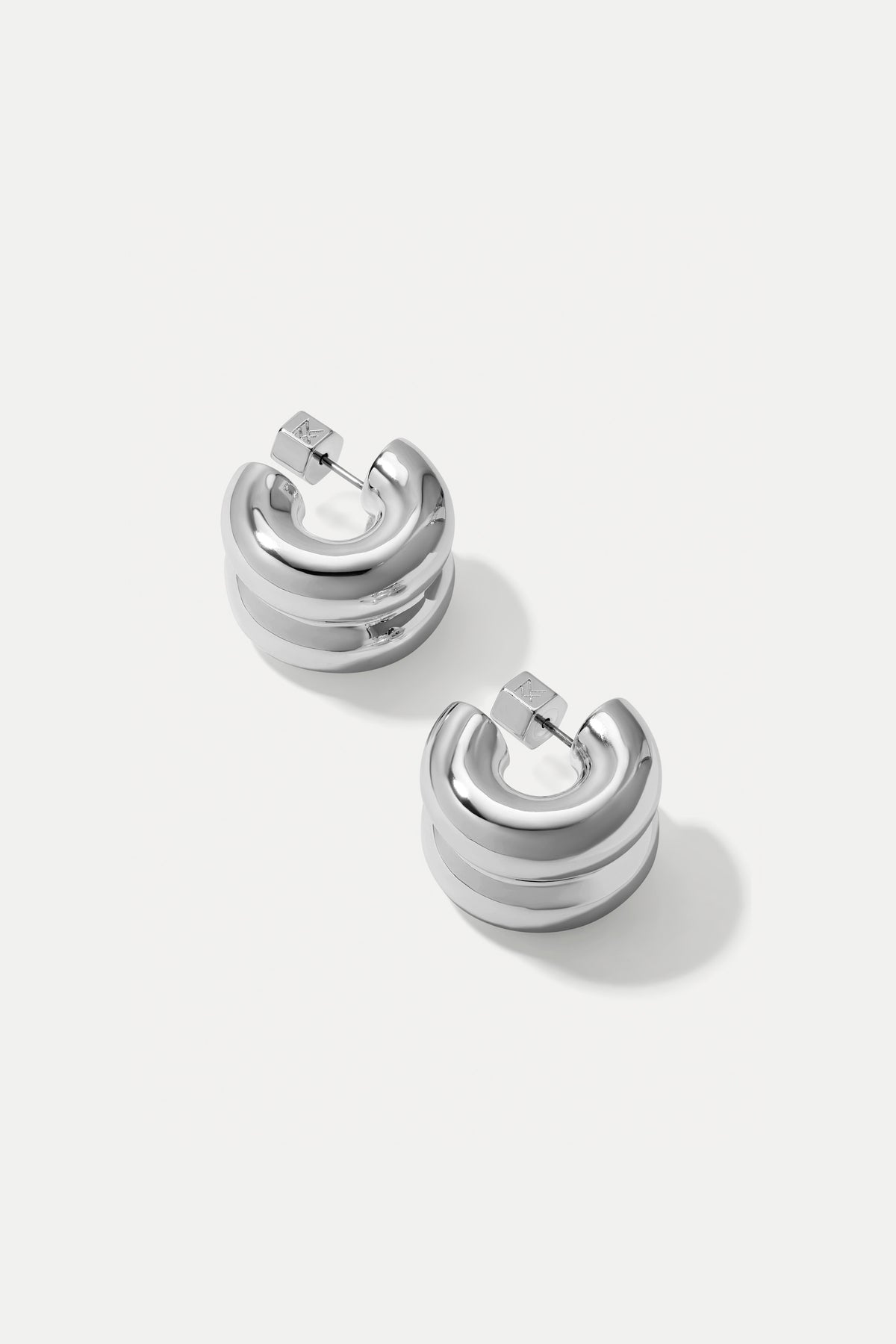 Silver double-layered Chloe huggie hoop earrings displayed on a clean white background.