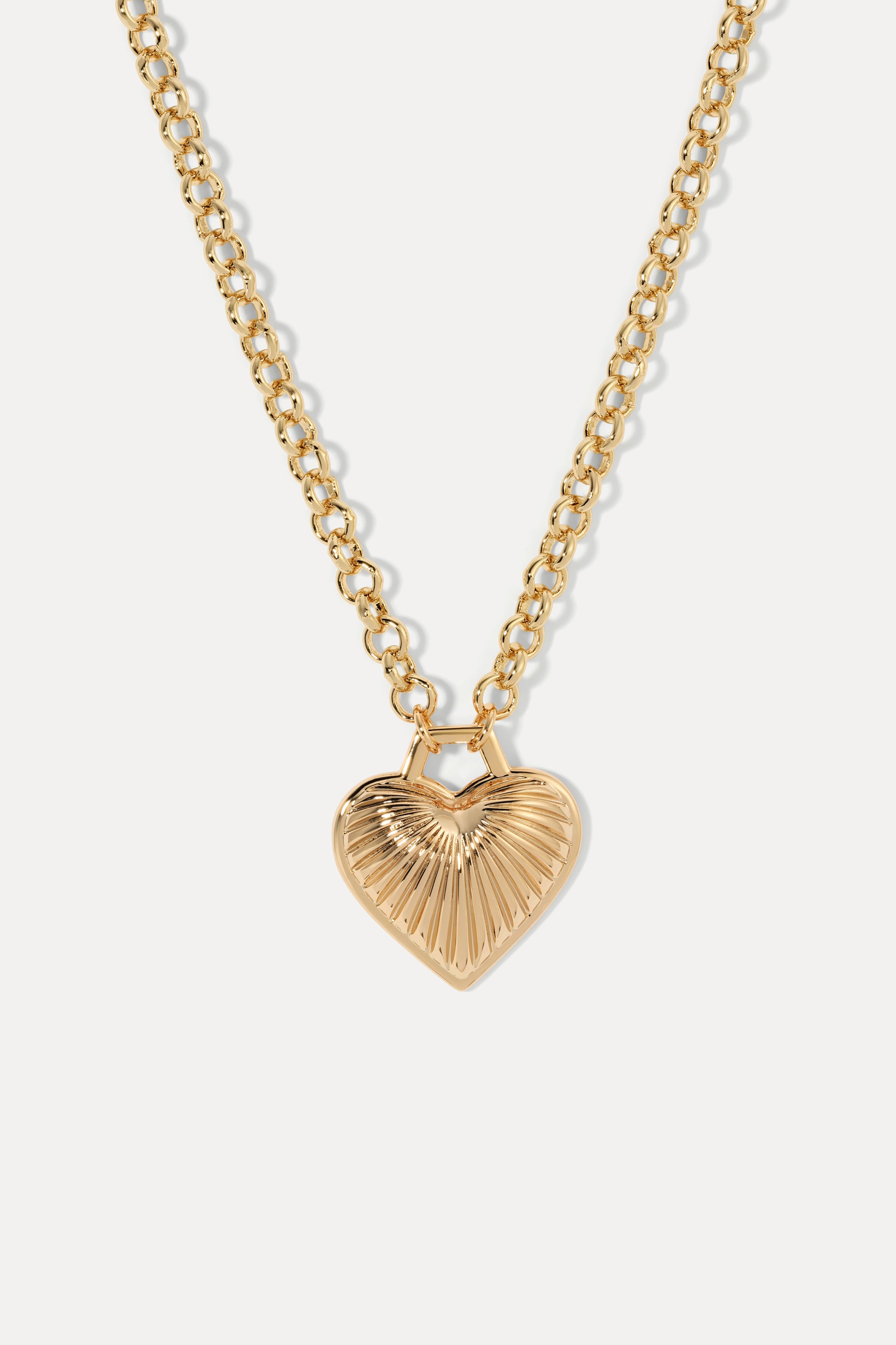 Gold Juliet pendant necklace with a textured ribbed design hanging on a gold rolo chain, displayed on a white background.