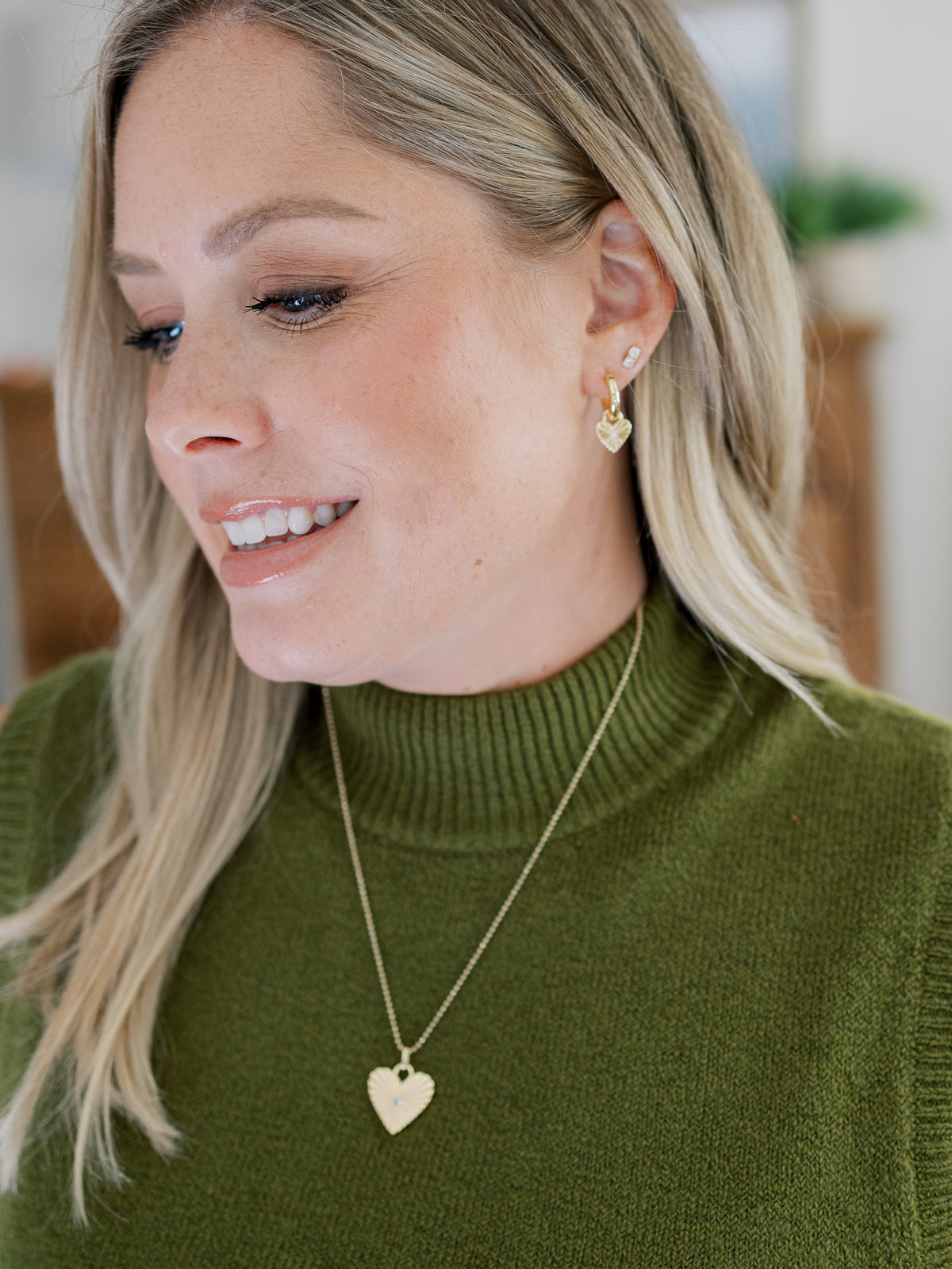 Influencer Kate Bryan wearing the gold Eleanor earring charms.
