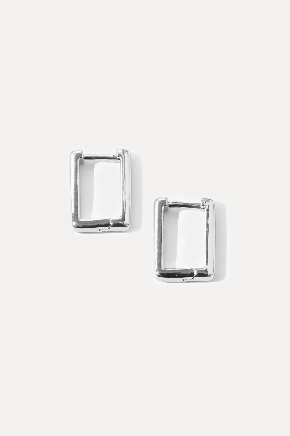 Pair of silver rectangular Kate Huggies displayed on a clean white background.