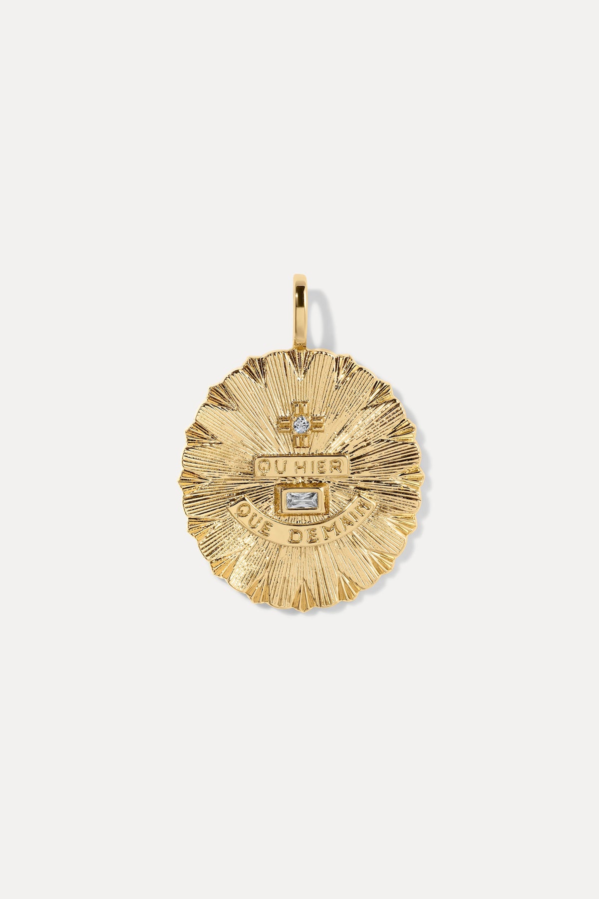 Round textured gold vintage-inspired charm with French lettering and clear gem accents on a bail.