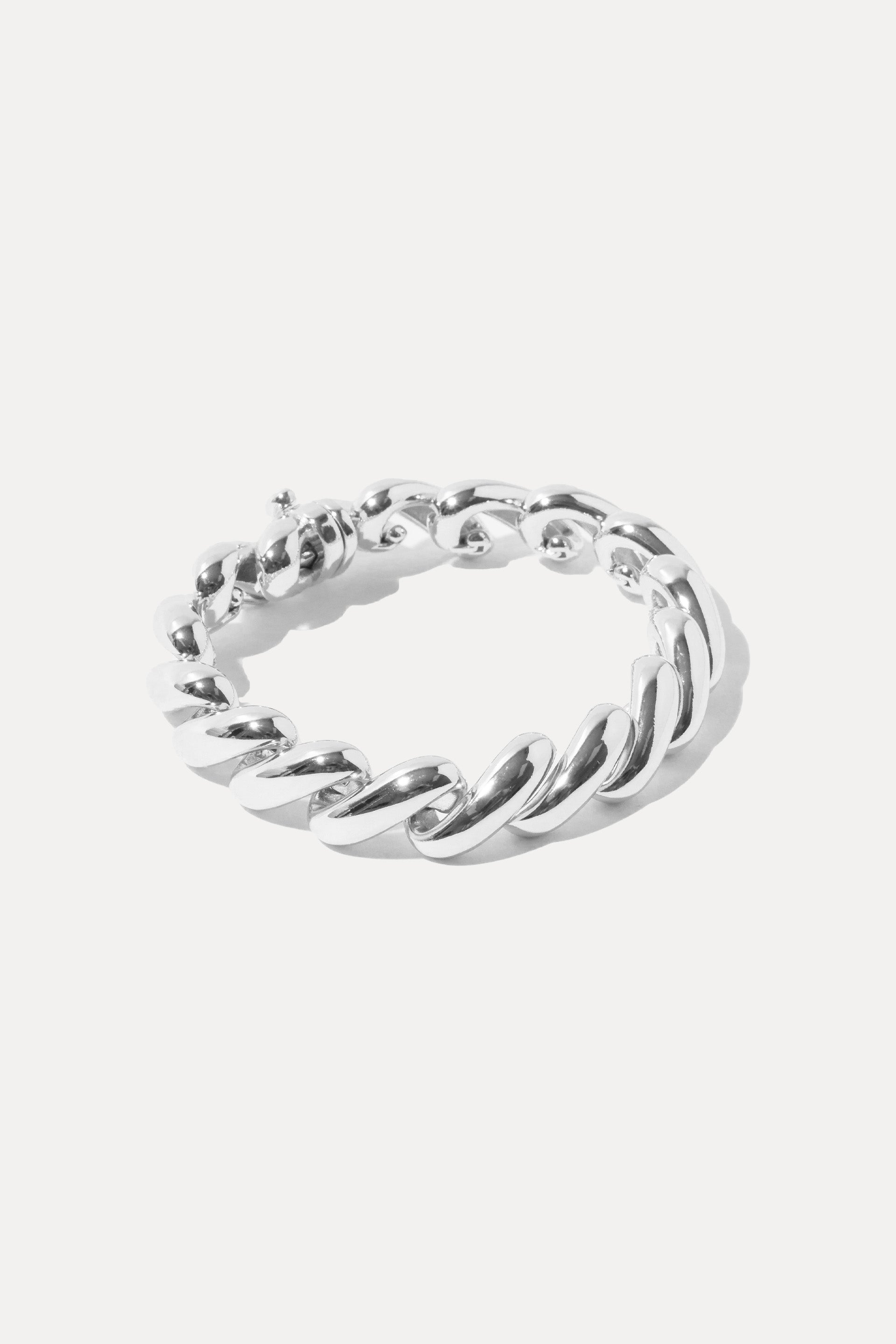 Silver Paige chunky curb chain bracelet displayed in an oval on a white background.