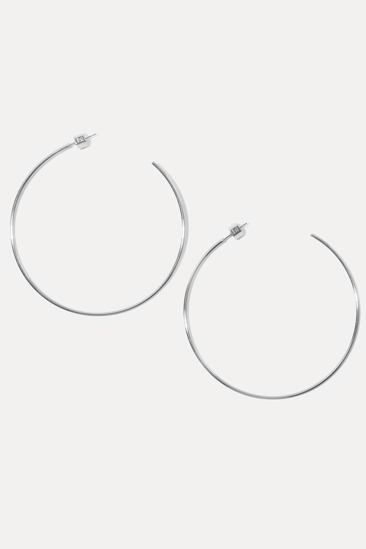 Pair of silver Rylan Hoops displayed flat on a white background showing custom earring backs.