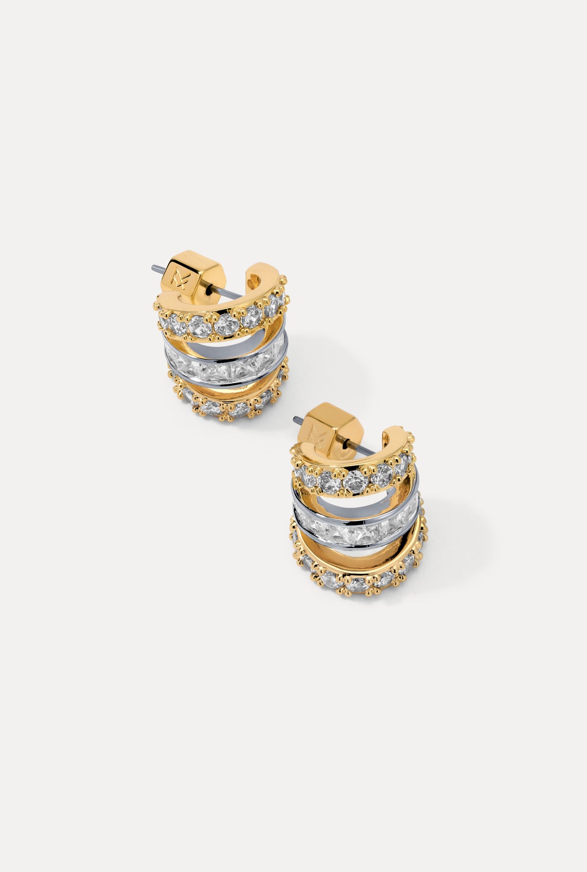 Second image of a pair of gold Sabrina Huggies on a white background showing triple-band look with CZ accents.
