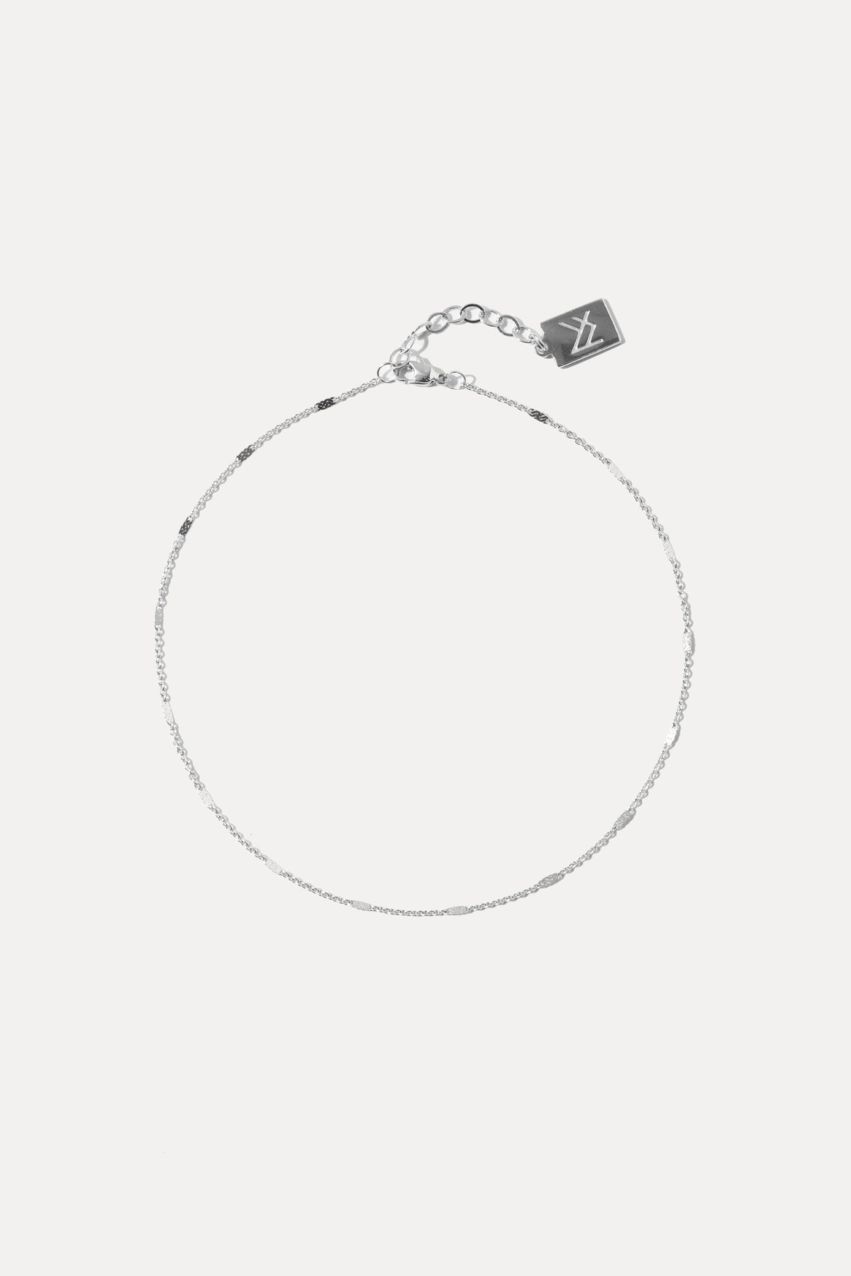 Silver cable chain chain anklet displayed against a plain white background.