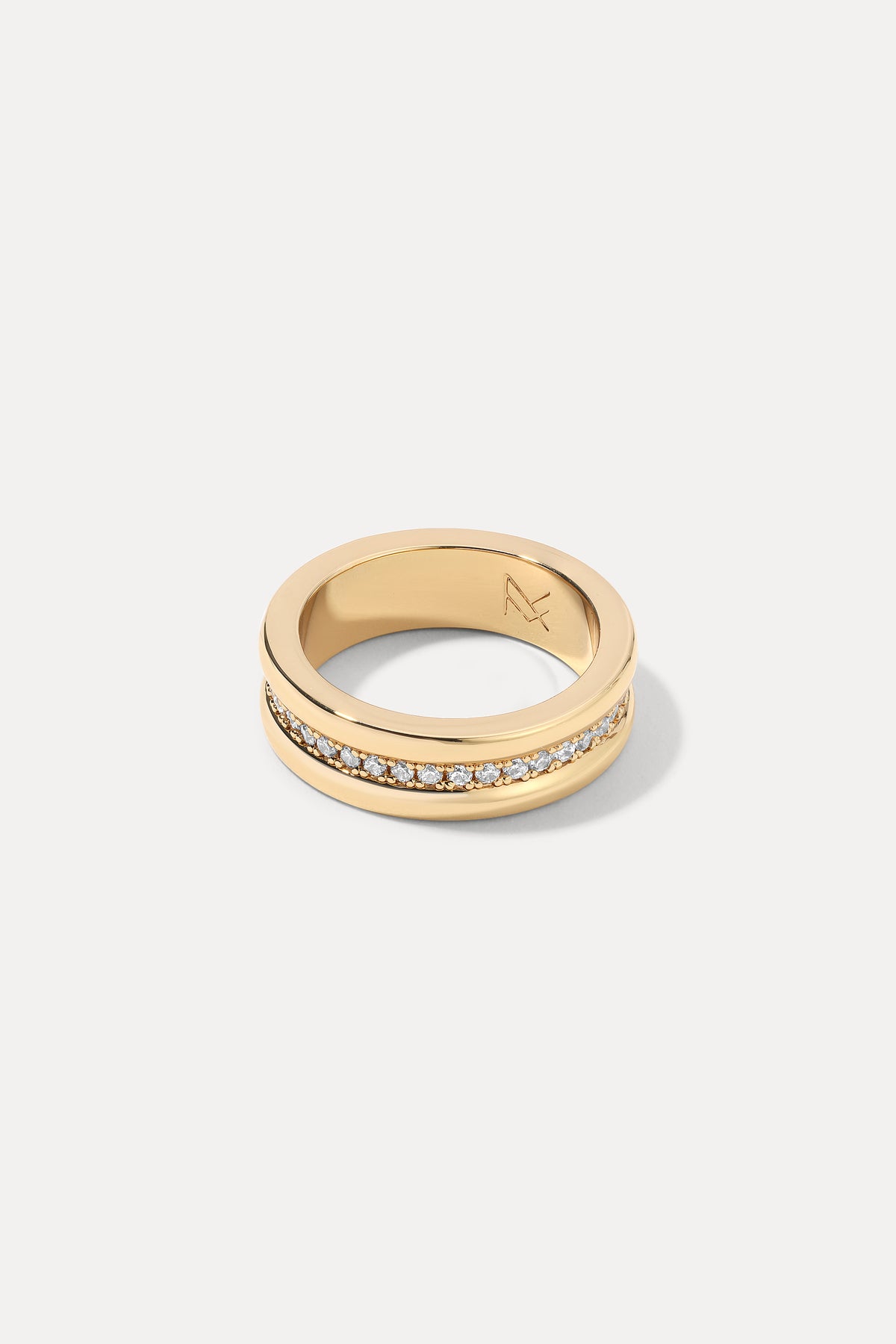 Gold Ariana cigar band ring set with a row of CZ stones on a white background