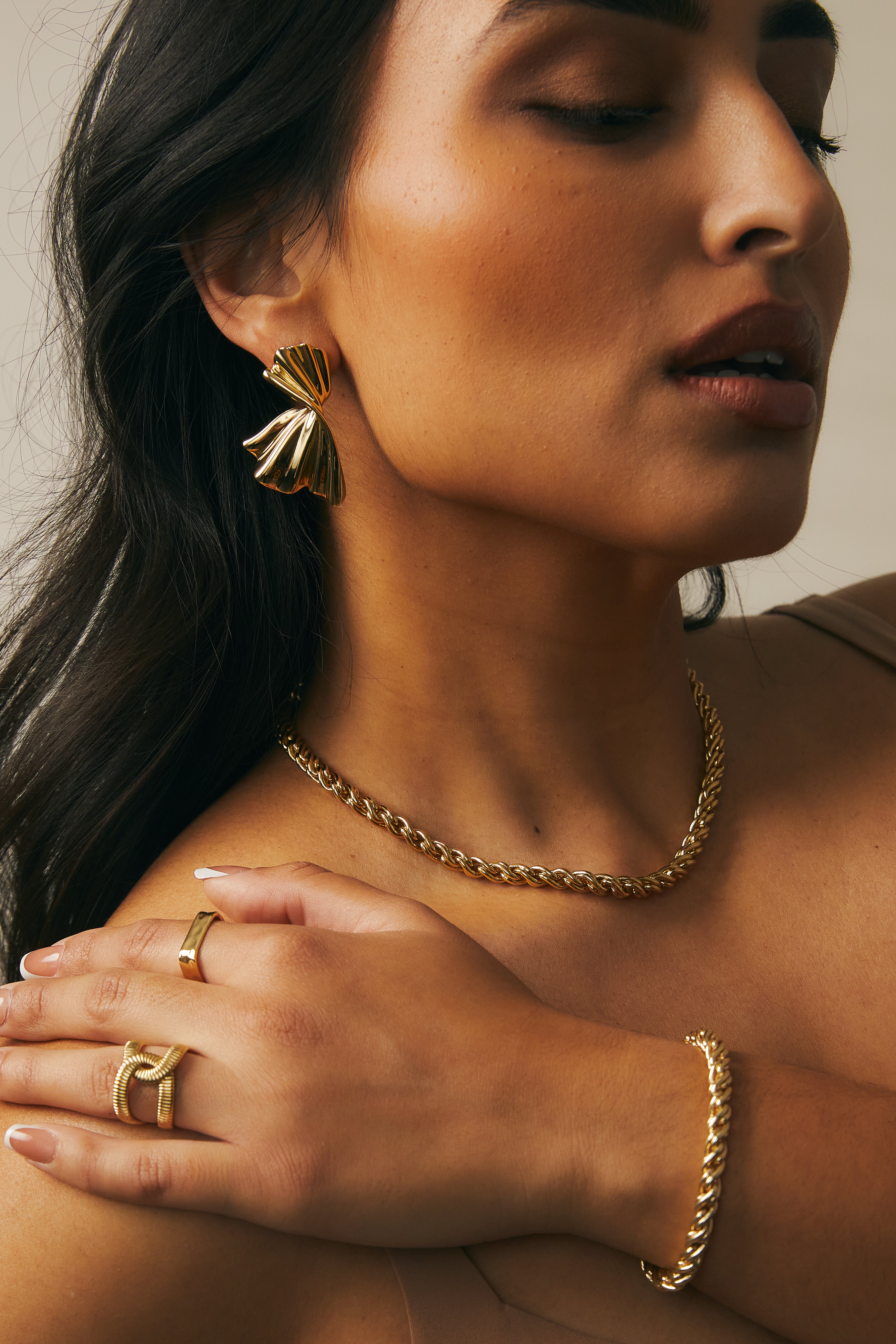 Close-up side profile highlighting how the Adriana gold rope chain Necklace sits along the collarbone.