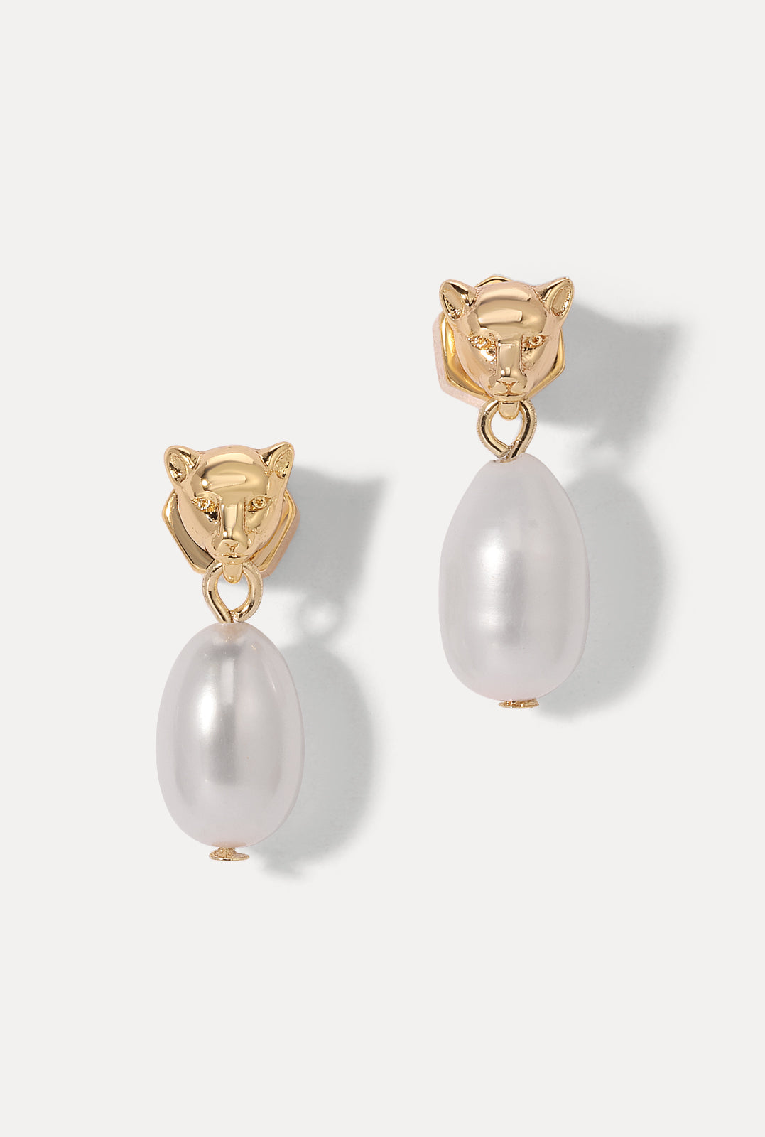 Pair of gold Panther Pearl Earrings with panther heads and dangling pearls on a white background.