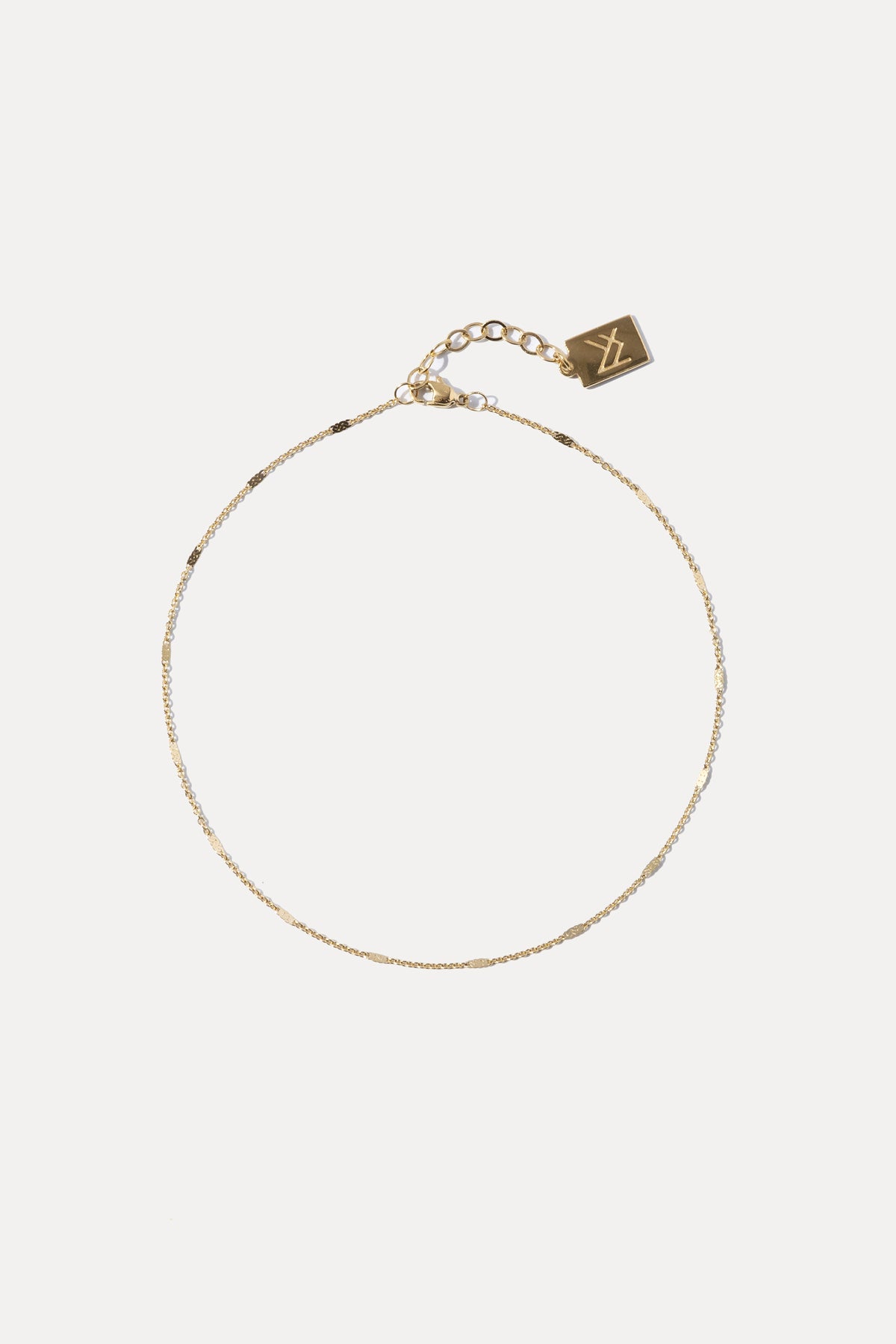 Gold cable chain chain anklet displayed against a plain white background.