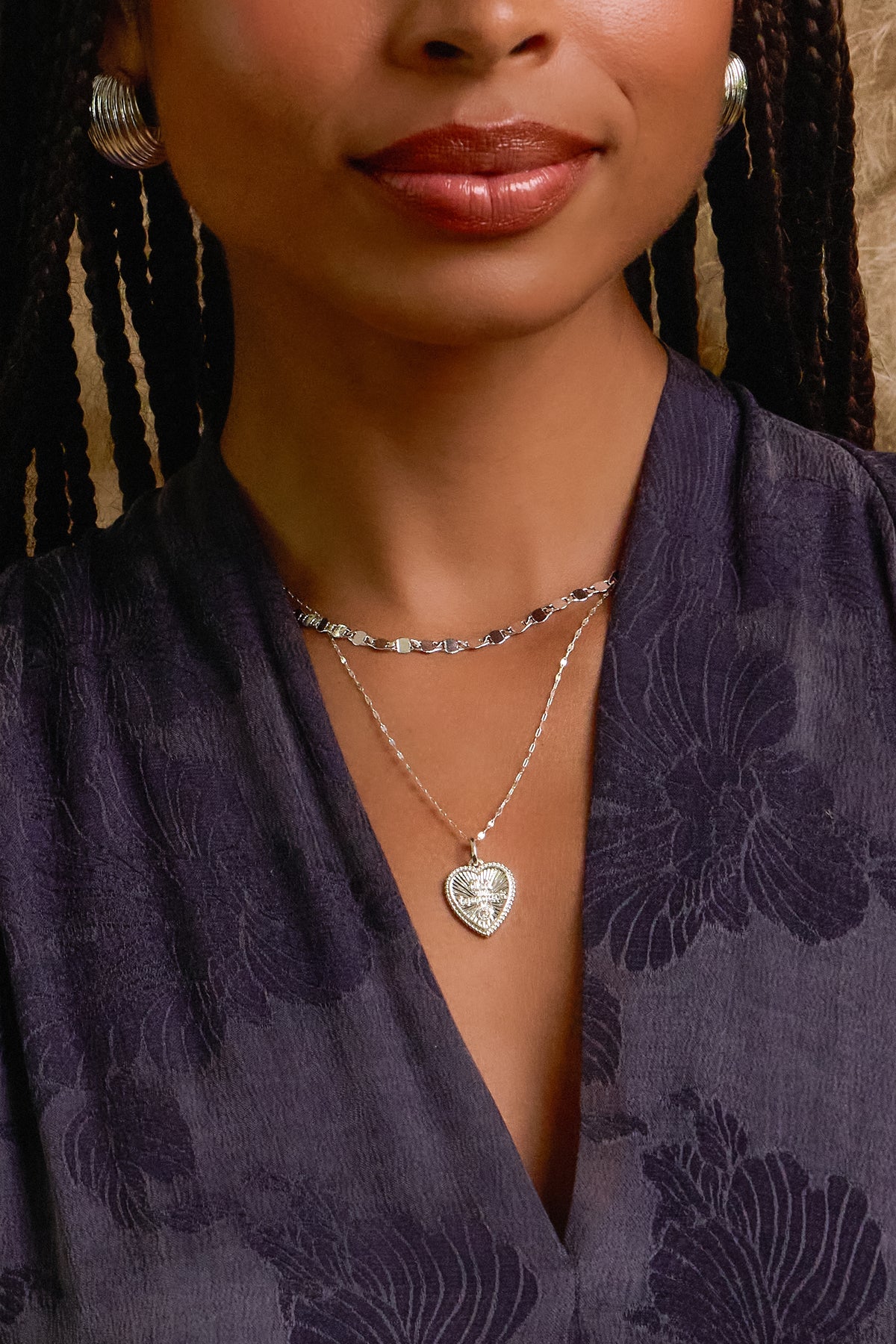 Model wearing silver Ava necklace, Forever on nora chain, and florence ribbed dome hoop earrings
