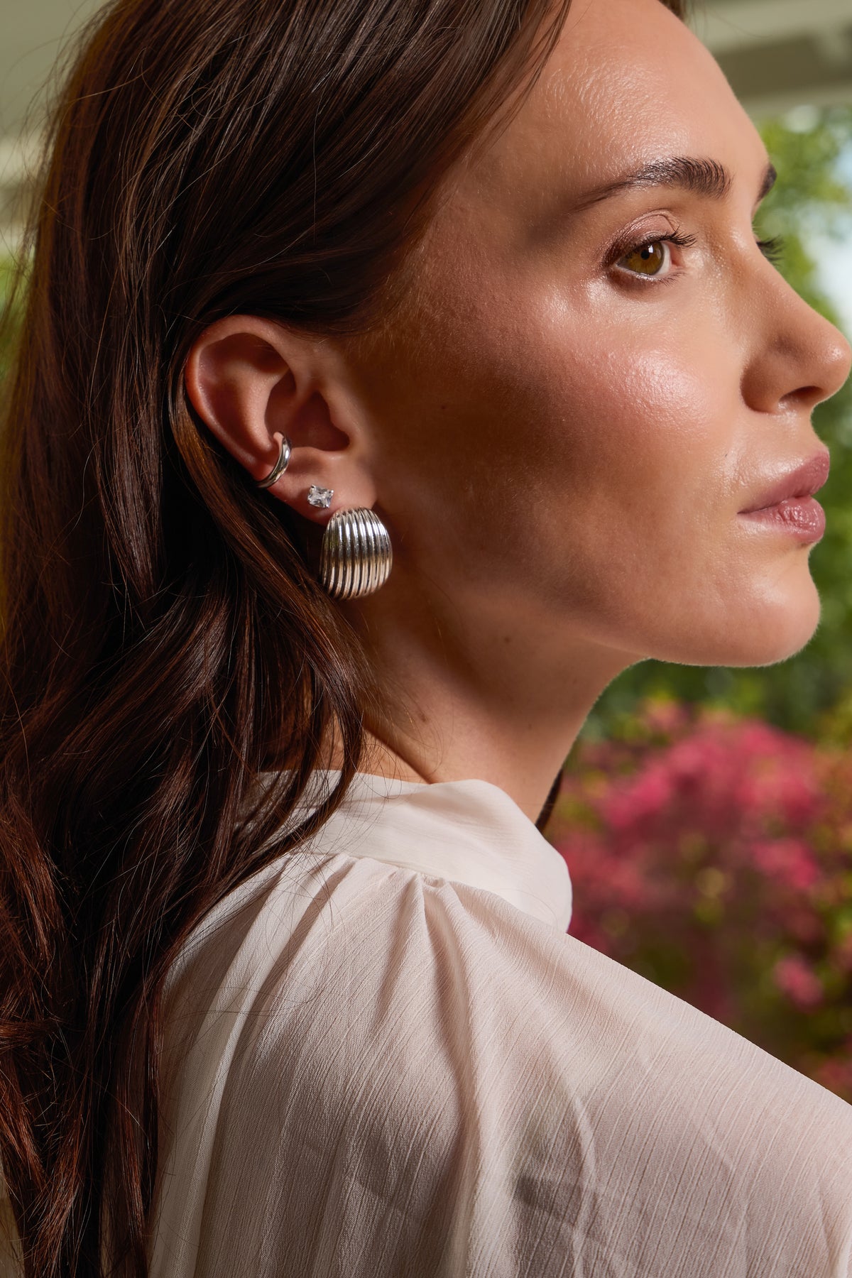 Model wearing silver Florence ribbed dome hoop earring stacked with a bella cuff and sophia stud.
