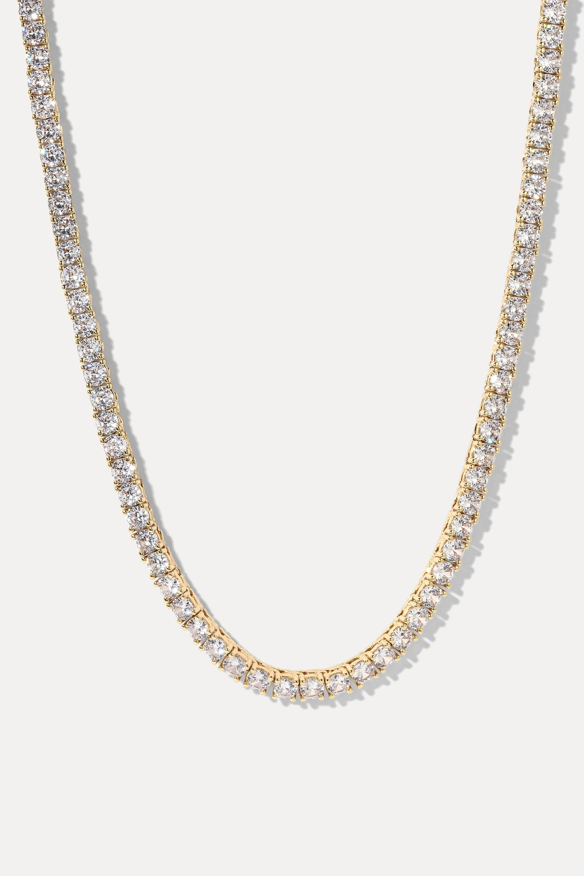Audrey Gold Tennis Necklace displayed in a U-shape loop on a plain white background.