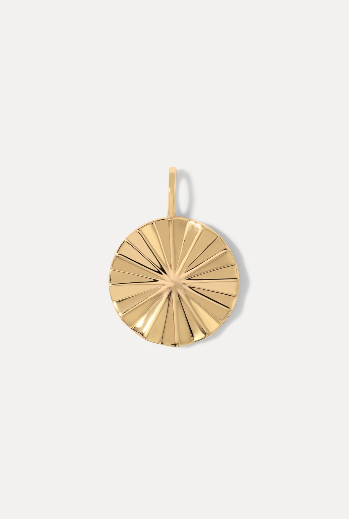 Bridget Gold Charm with a circular shape and textured sunburst pattern on a white background.