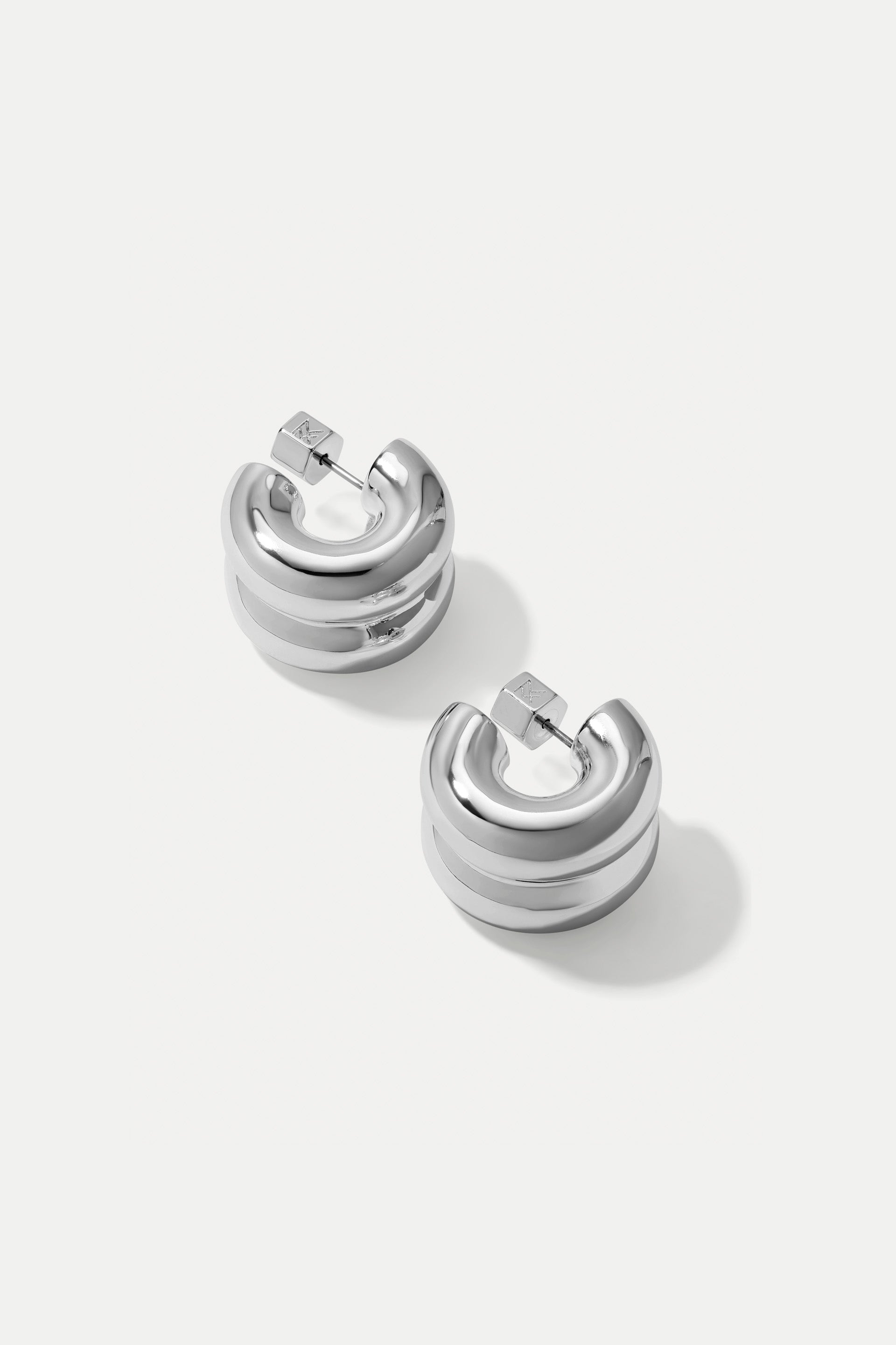 Silver double-layered Chloe huggie hoop earrings displayed on a clean white background.
