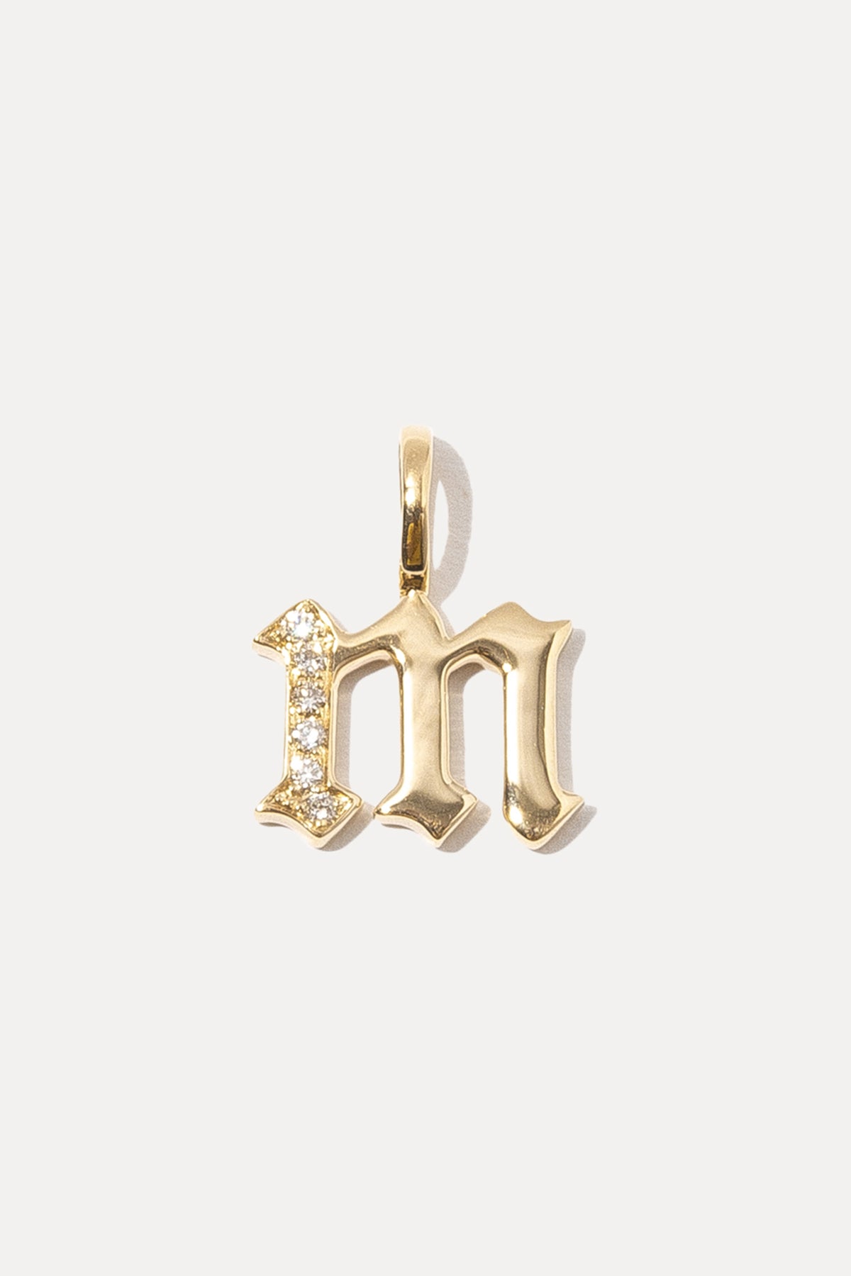 Diamond 14K gold gothic initial charm displayed against a plain white background.