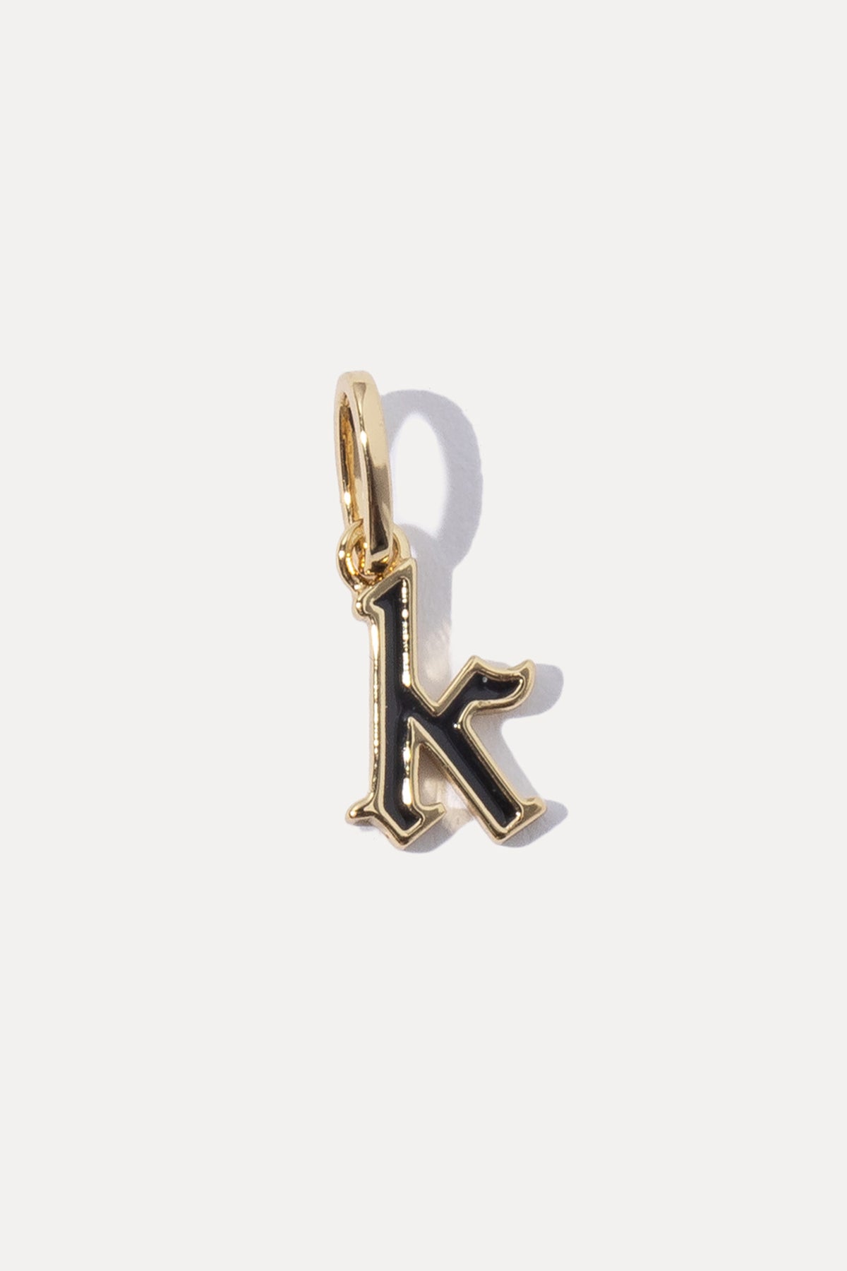 Gold Enamel Initial Charm in lowercase letter K with black enamel fill on a white background.