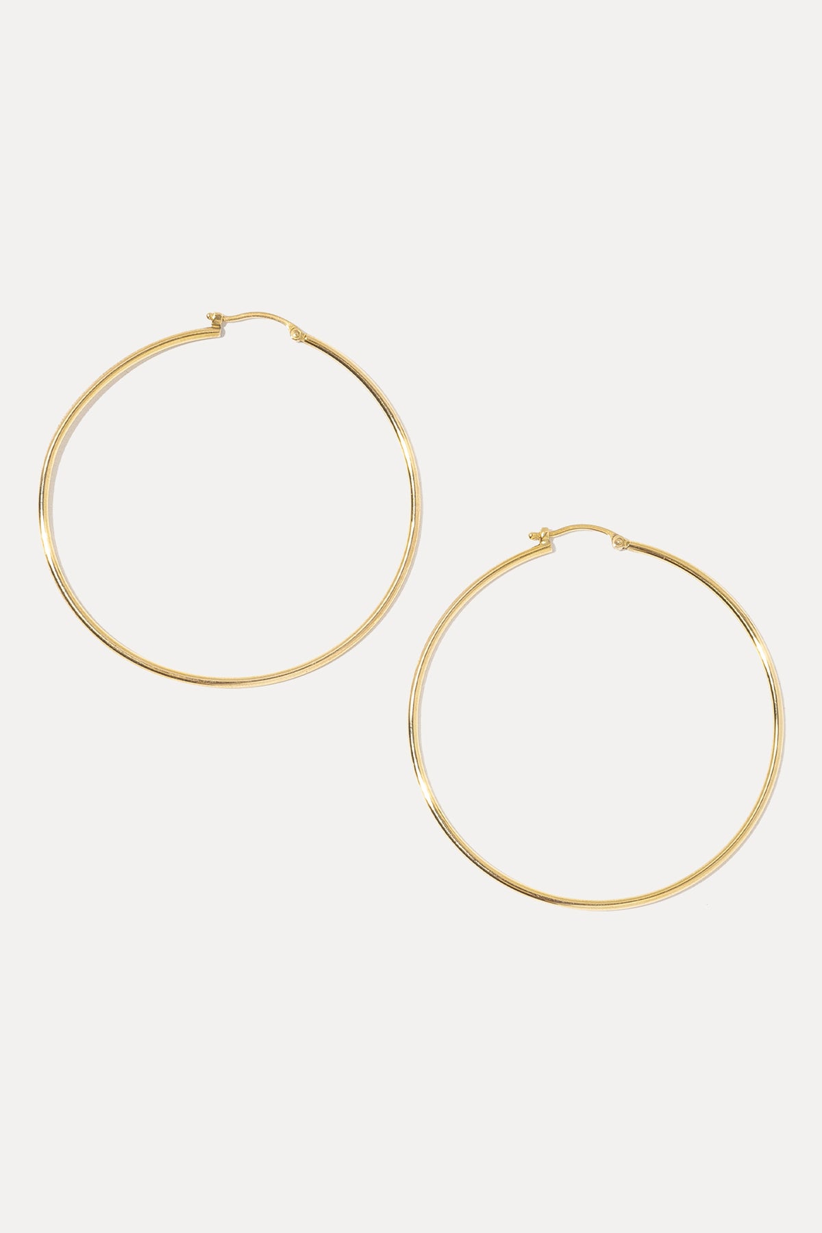 Pair of 14K gold endless hoop earrings displayed against a plain white background.