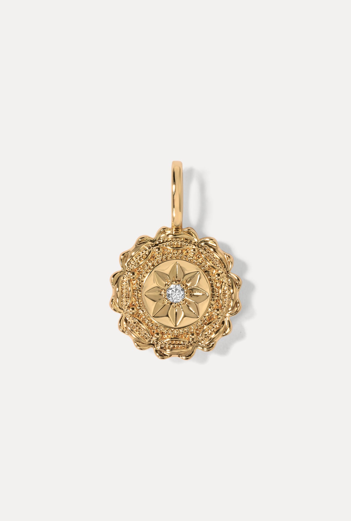 Gold Fleur Charm featuring a textured antique medallion design with a center CZ on a white background.