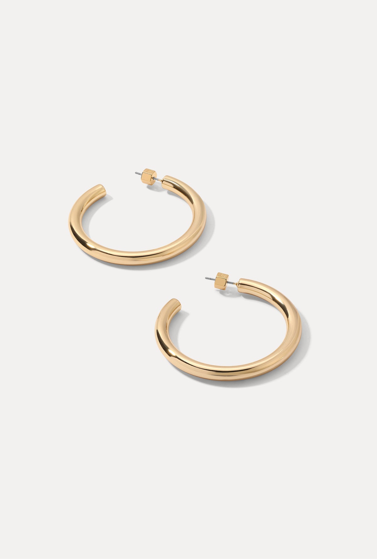 Pair of gold Freda Hoops displayed on a clean white background.