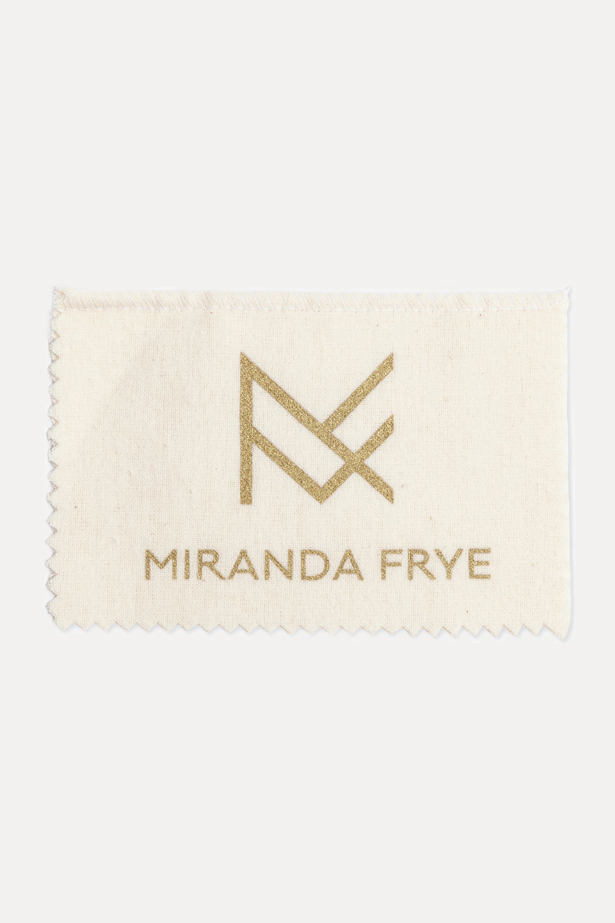 Image of the Miranda Frye gold polishing cloth with logo against a white background.