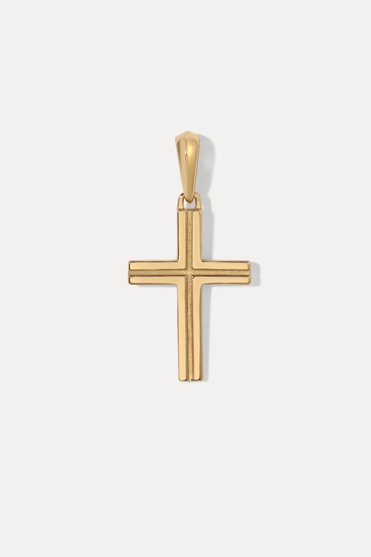 Studio shot displaying the gold vermeil cross pendant centered on a delicate cable chain.