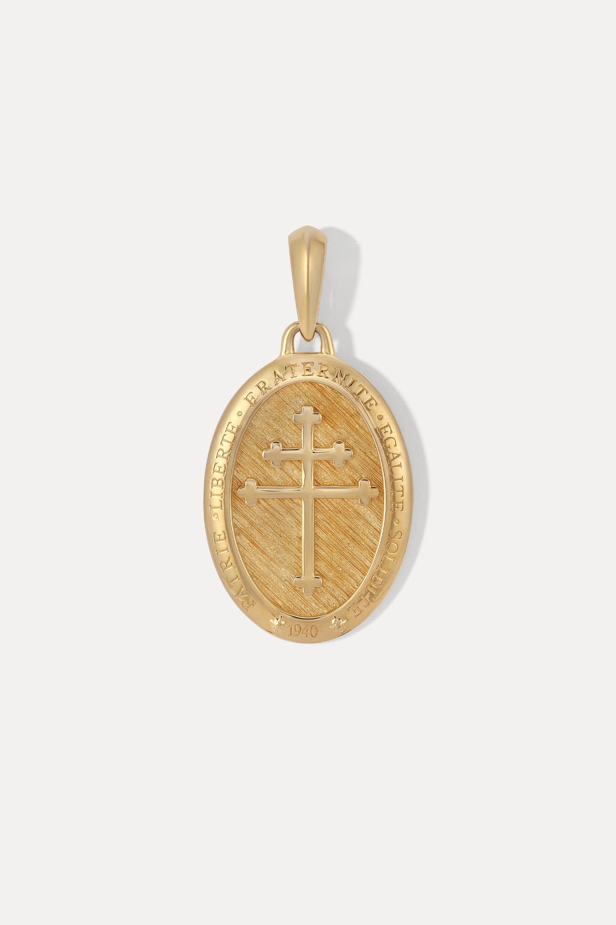 A gold vermeil oval pendant featuring a black enamel background with a raised silver cross in the center.