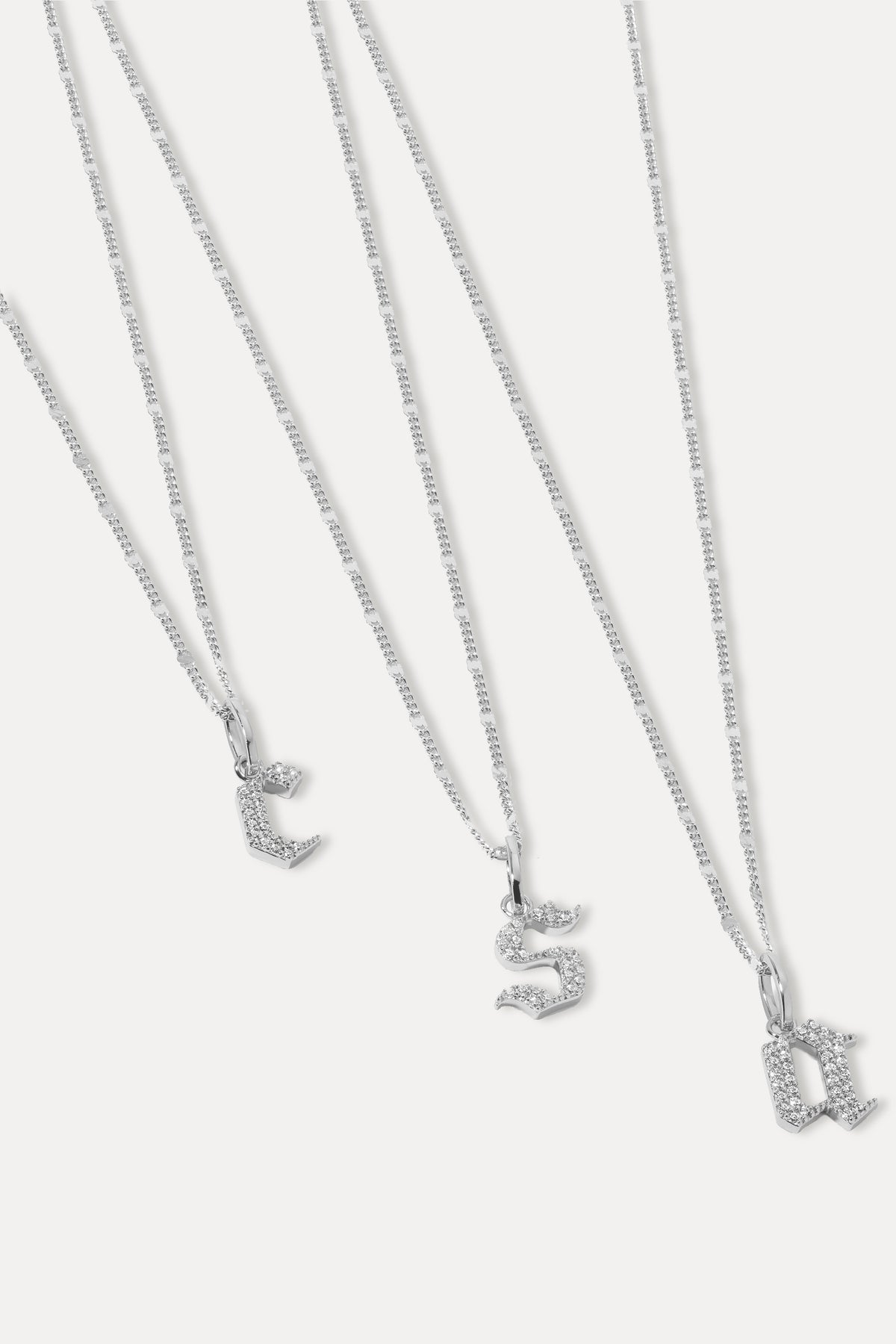 Silver gothic font initial pendant attached to a silver chain displayed against a plain white background.