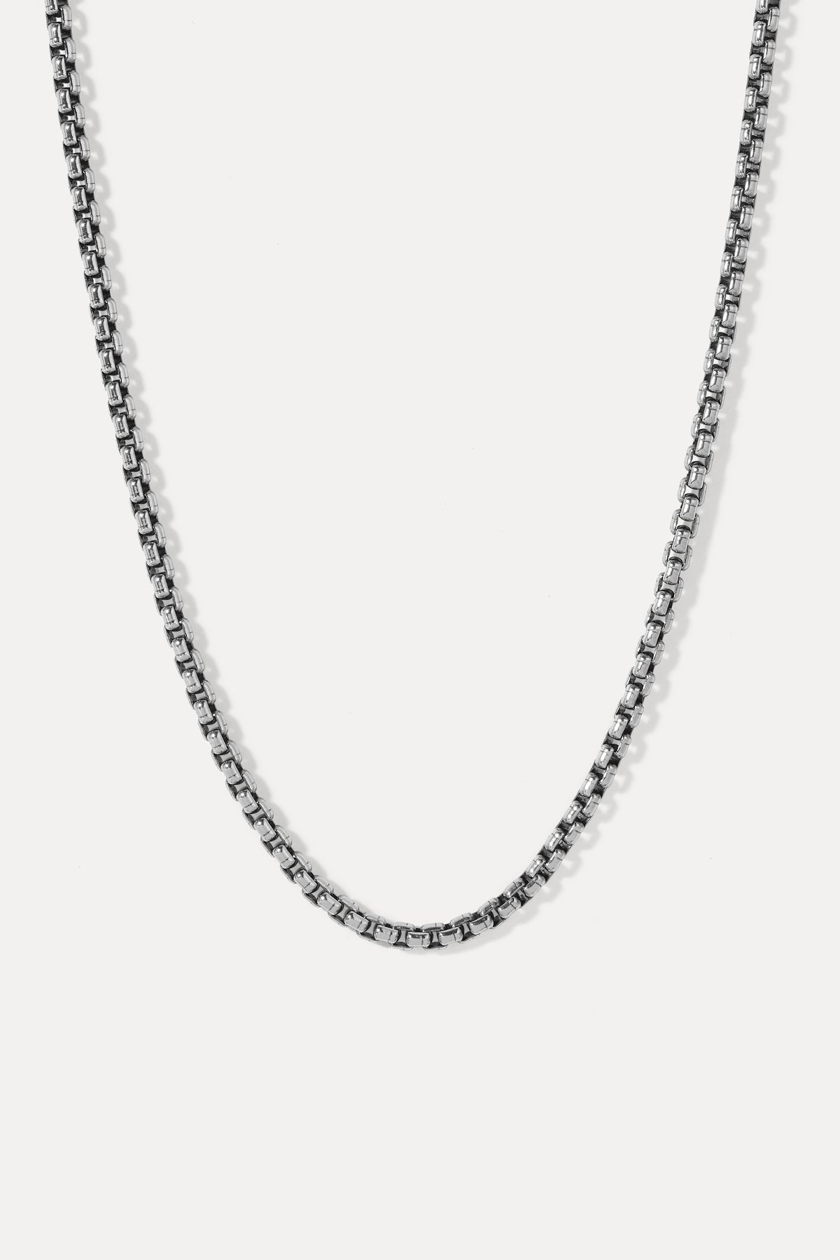 Studio lay-flat showing the rounded-box sterling silver links and deep oxidized patina.