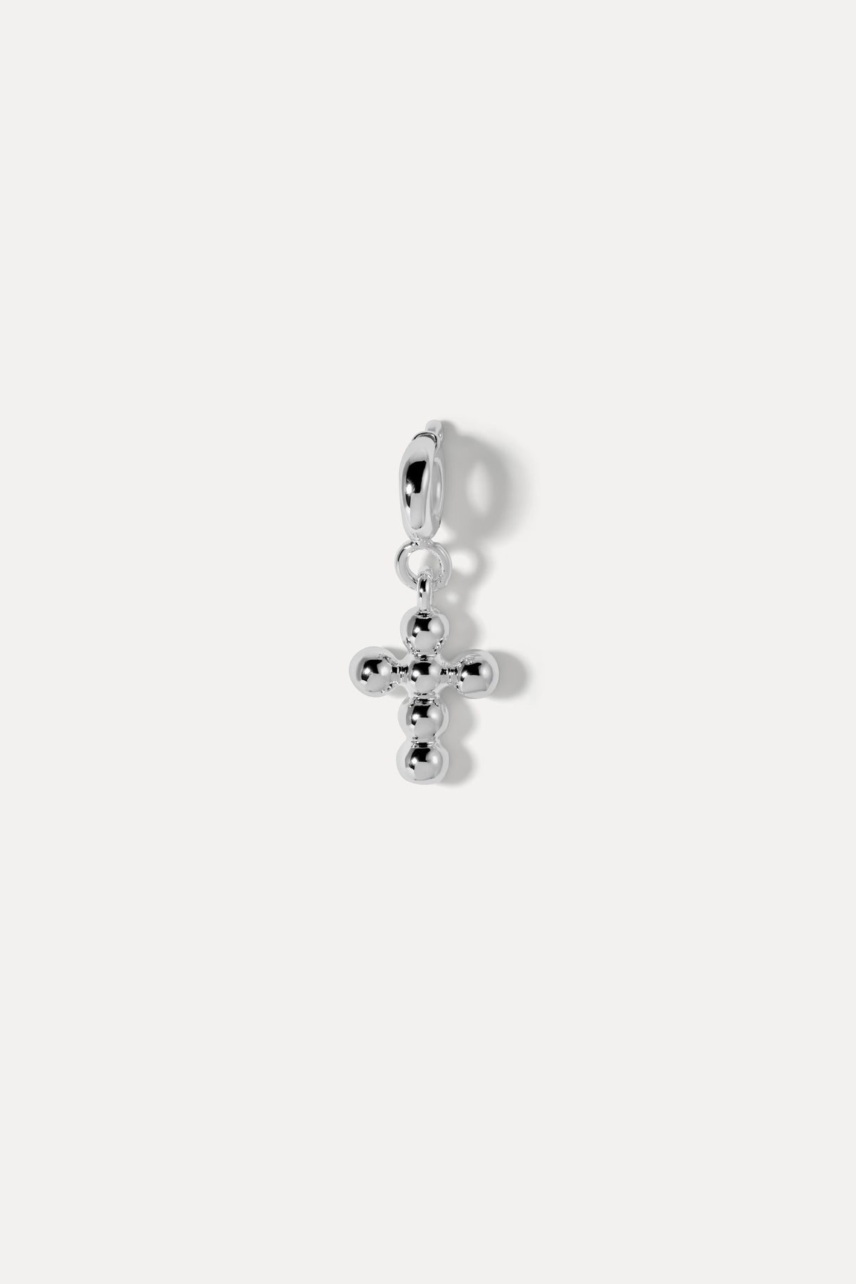 Silver beaded cross charm with a hinged clip-on bail against a plain white background.