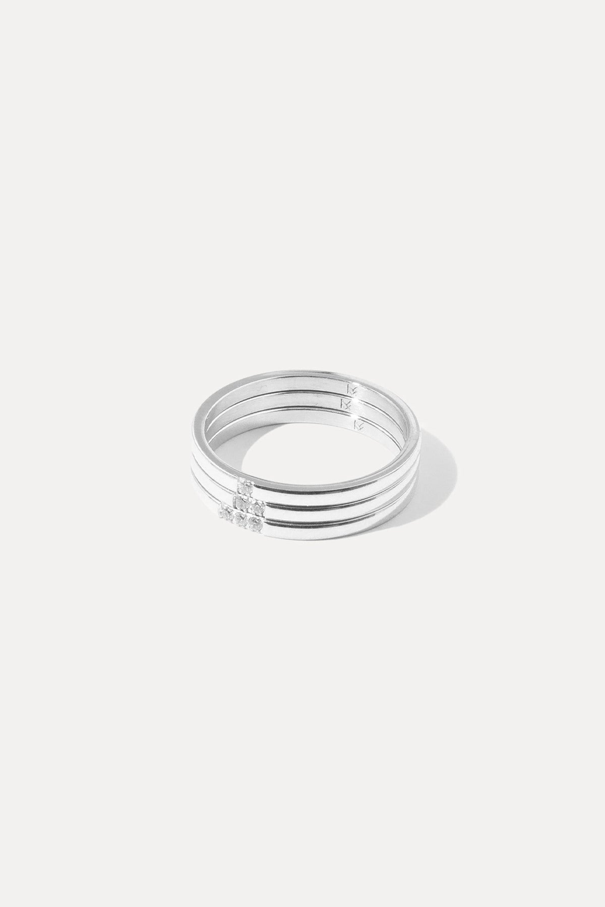 Set of three silver Leah stacking rings with subtle crystal accents, centered on a plain white background.