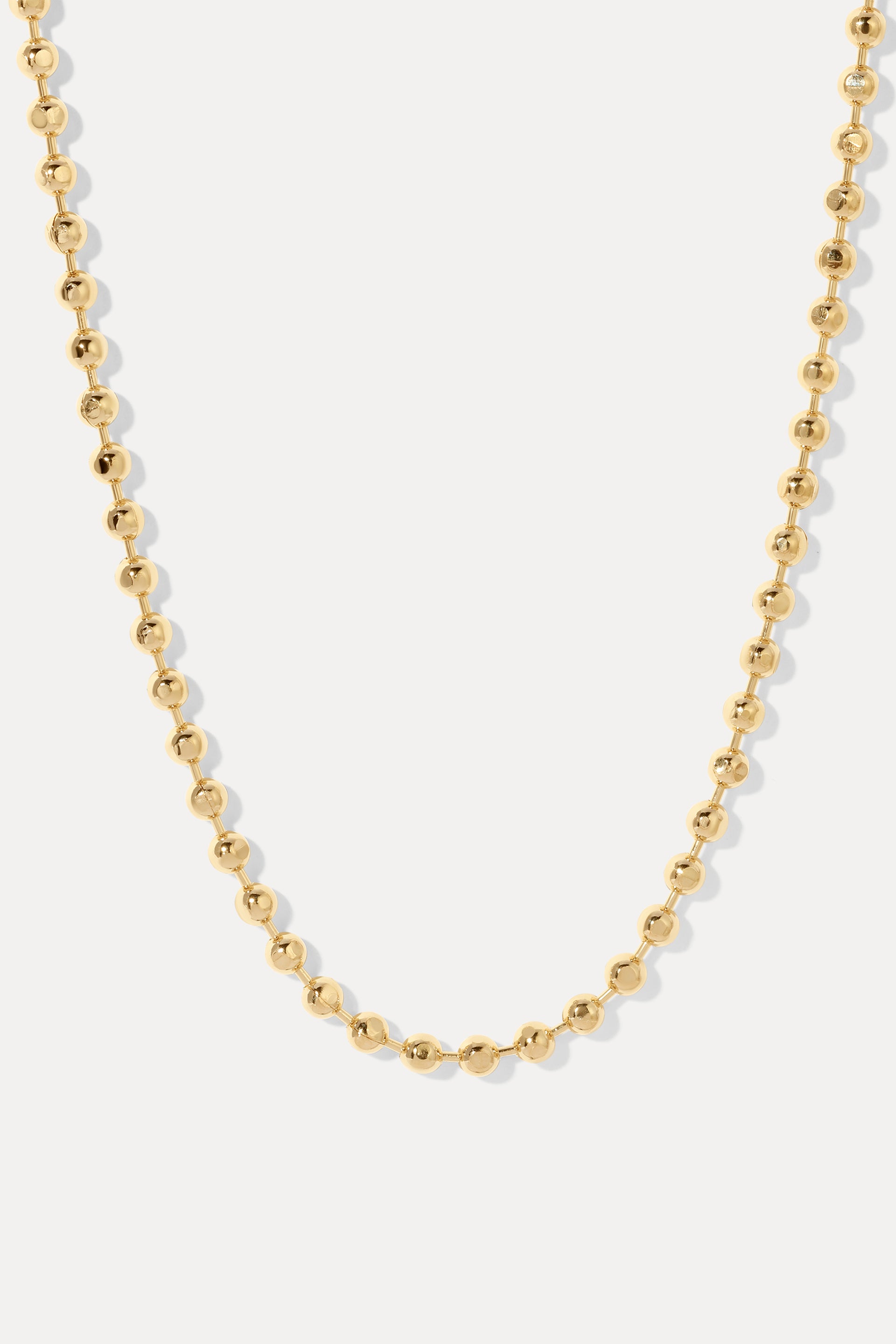 Gold London ball chain necklace with diamond-cut beads, displayed on a white background.