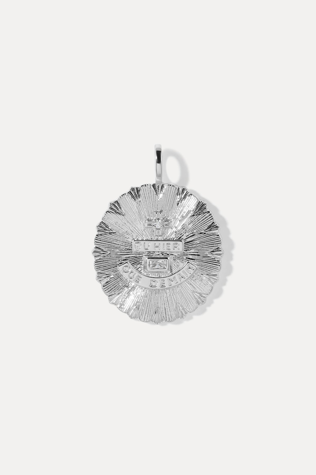 Round textured silver vintage-inspired charm with French lettering and clear gem accents on a bail.