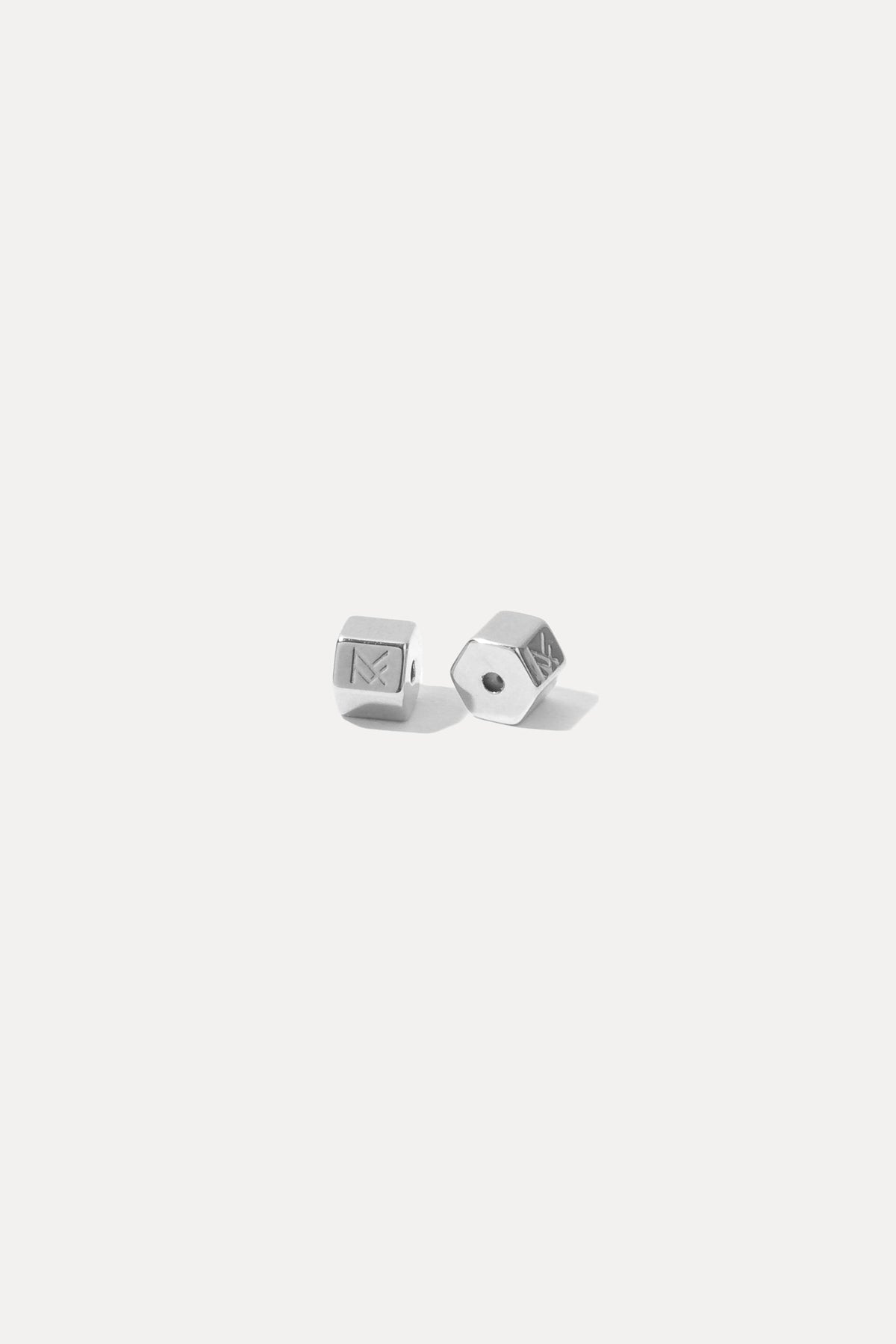 Pair of silver bullet earring backs displayed on a white background.