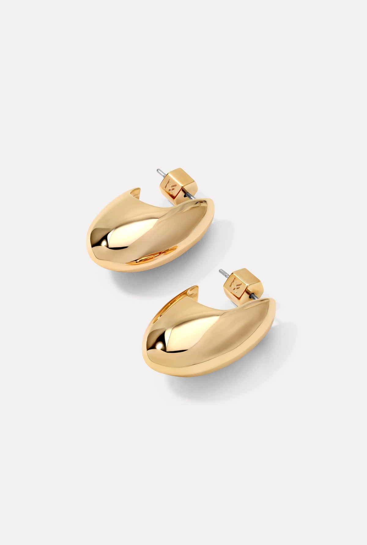 Pair of gold Margot Earrings featuring a chunky, sculpted design on a white background.