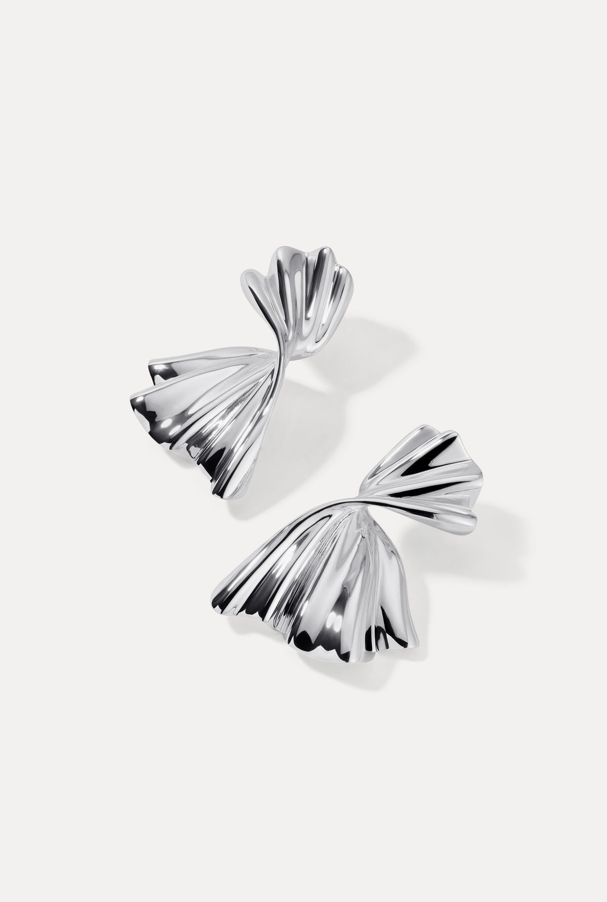 Silver Monica earrings displayed flat on a white background showing folded fan details.