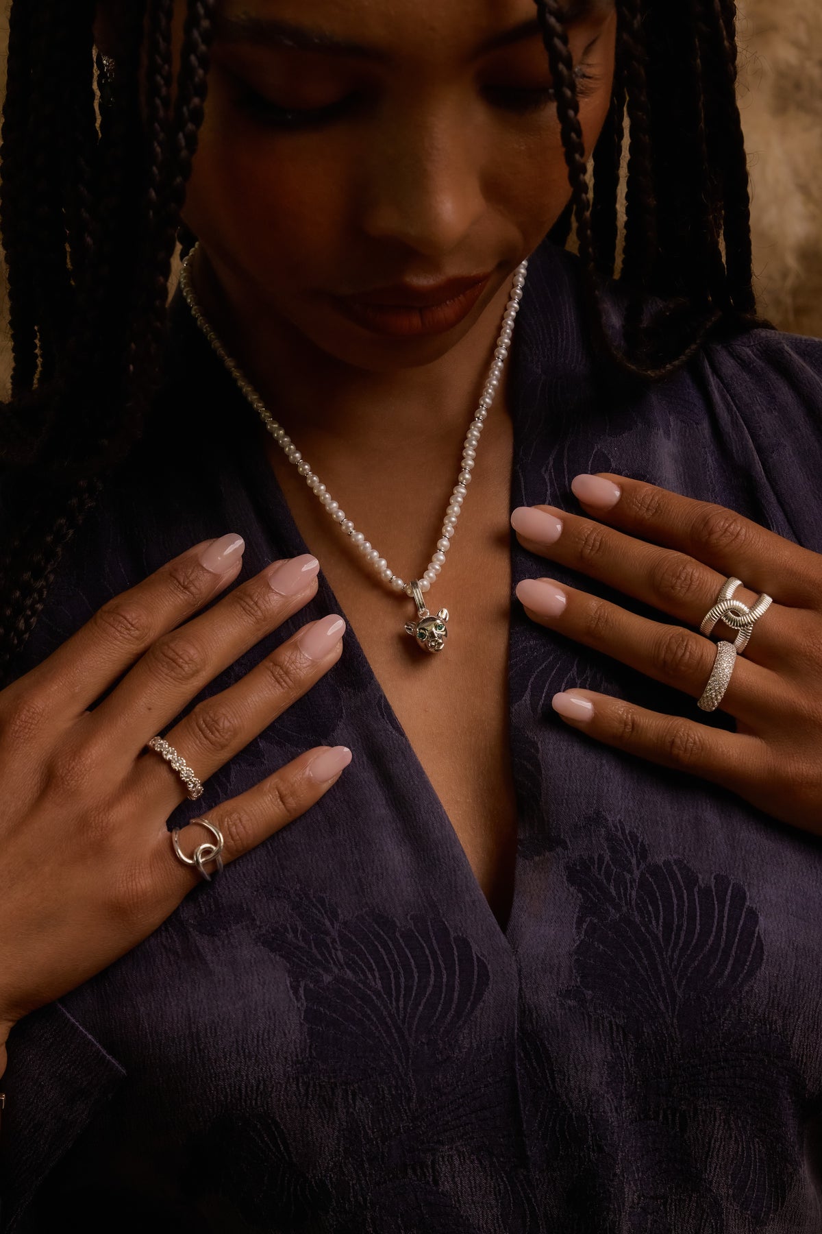Model wearing silver Panther Charm on bette necklace with Isabelle, Zoe, Vivienne, and Celine rings.