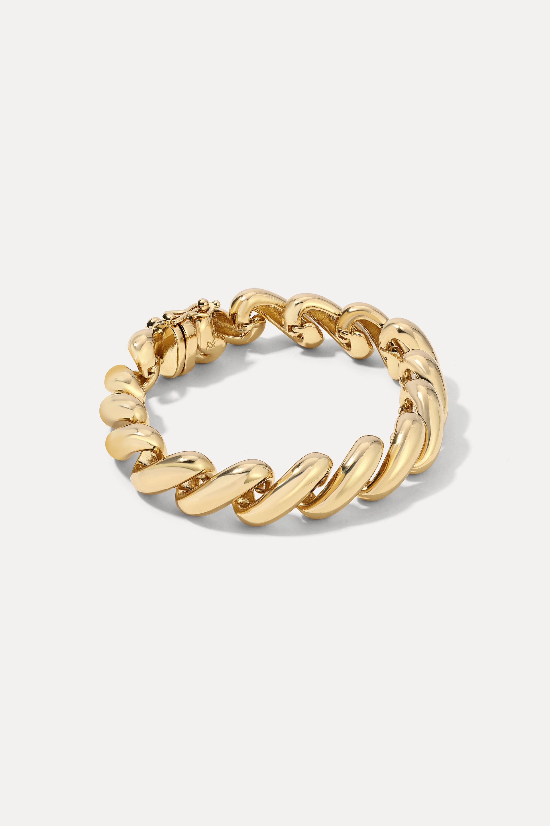 Gold Paige chunky curb chain bracelet displayed in an oval shape on a clean white background.