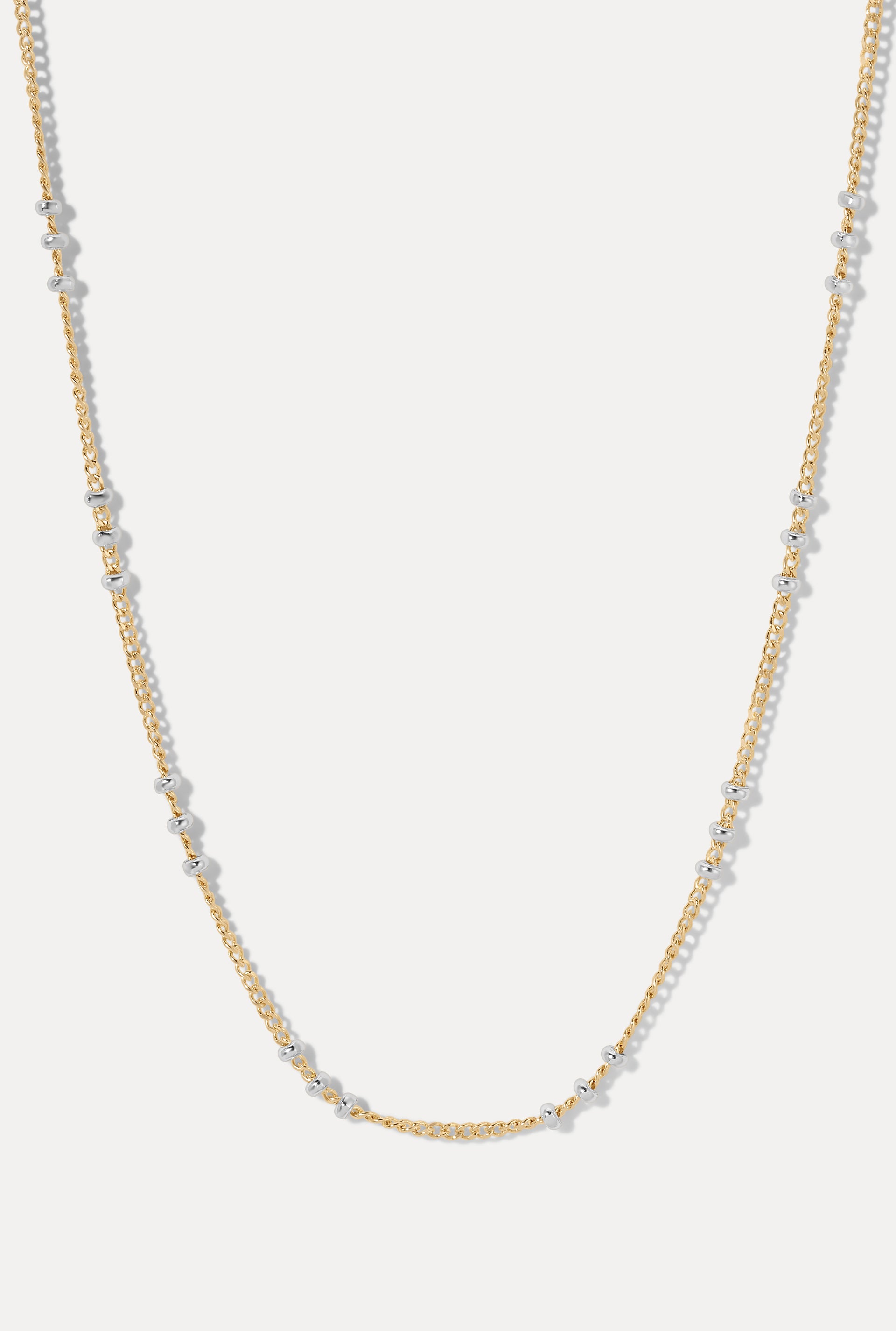 Gold-filled Poppy Chain with delicate sterling silver beads, displayed in a U-shape loop on a plain white background.