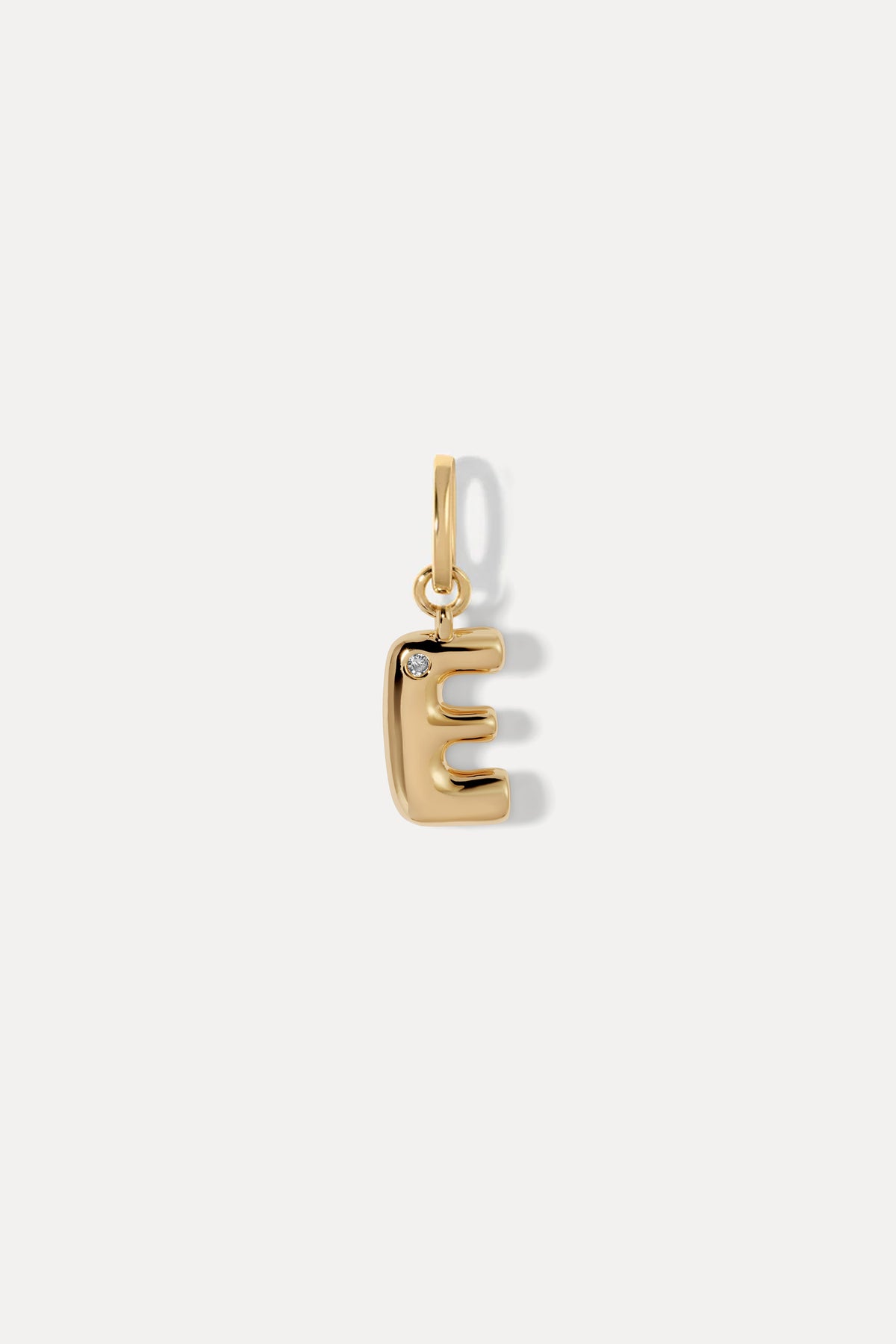 Open-block letter E Puffy initial necklace charm in gold on a bail against a plain white background.
