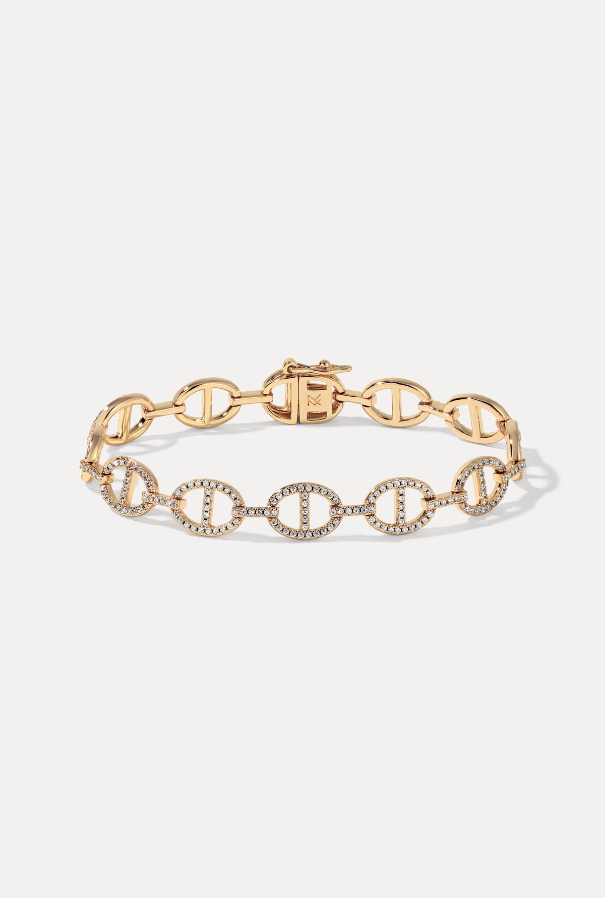 Gold Sienna oval link bracelet with pavé cubic zirconia displayed on a plain white background.