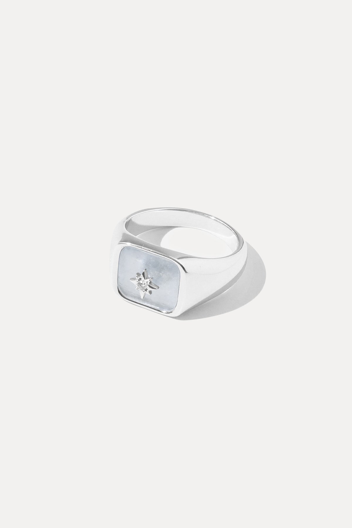 Silver Moonstone signet ring featuring an iridescent gemstone, centered on a plain white background.