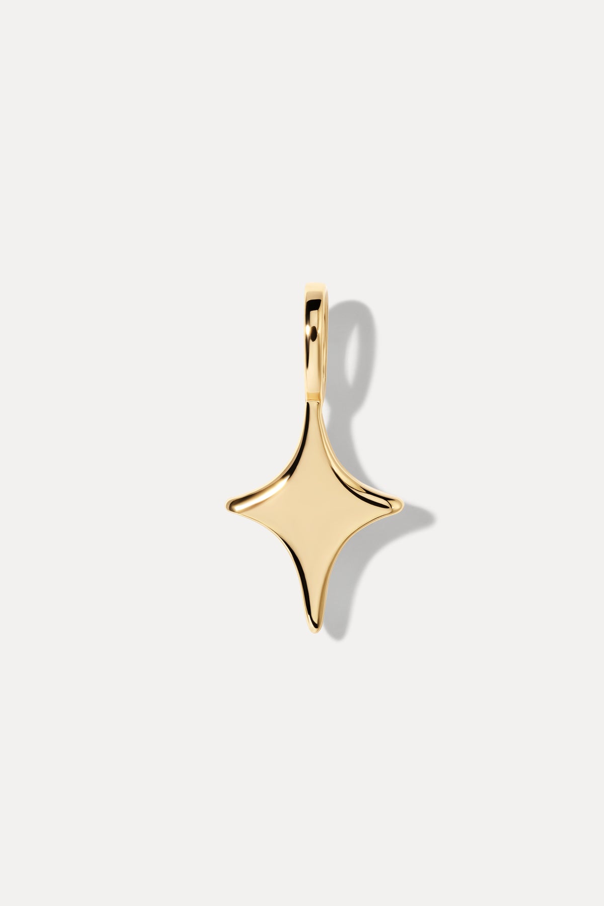 Gold star charm with a central sparkling stone set on a standard bail against a plain white background.