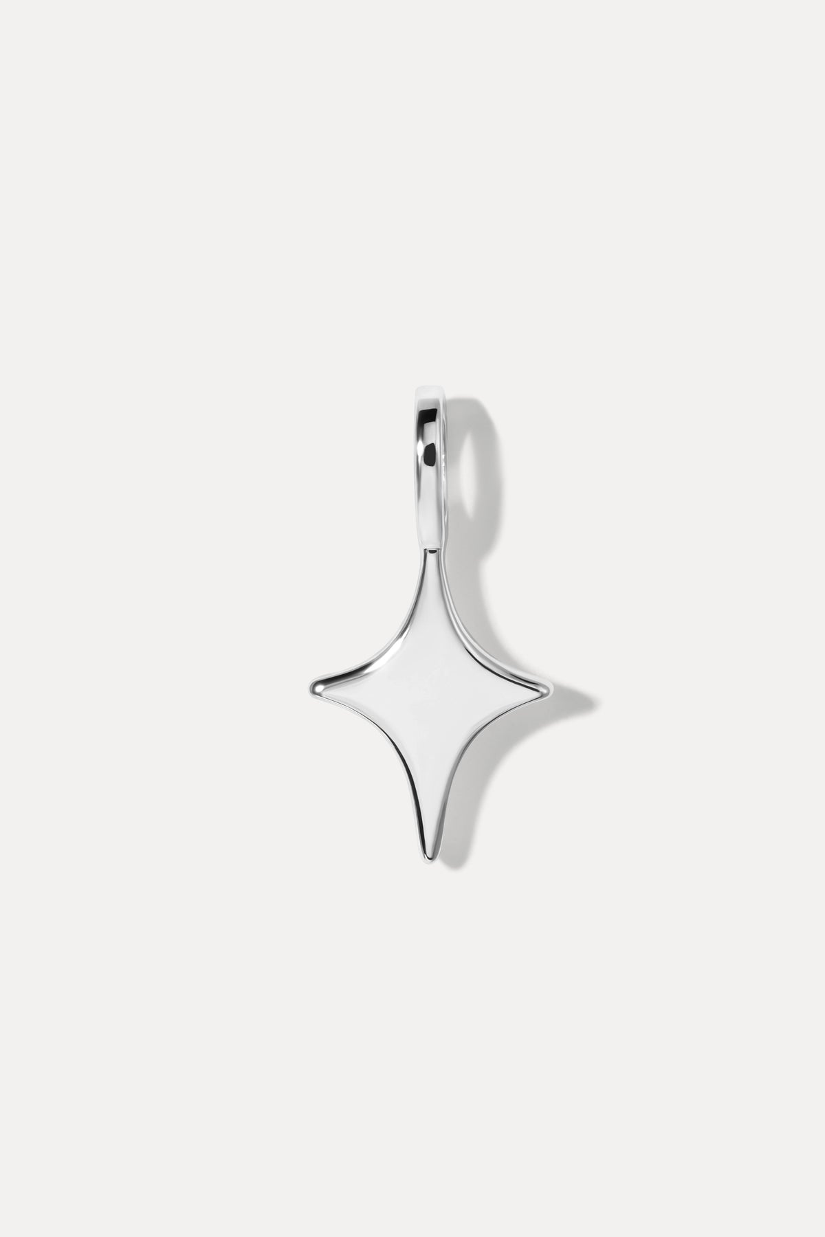 Silver star charm with a central sparkling stone set on a standard bail against a plain white background.