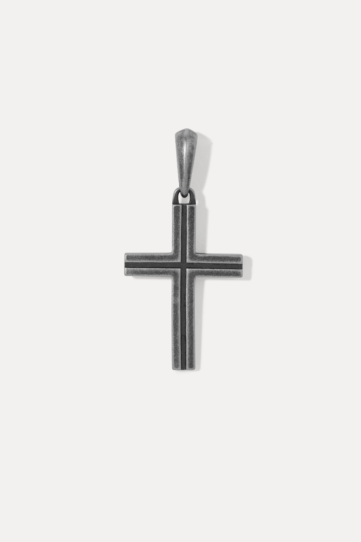 Studio shot displaying the sterling silver cross pendant with it's surface detail against a white background.