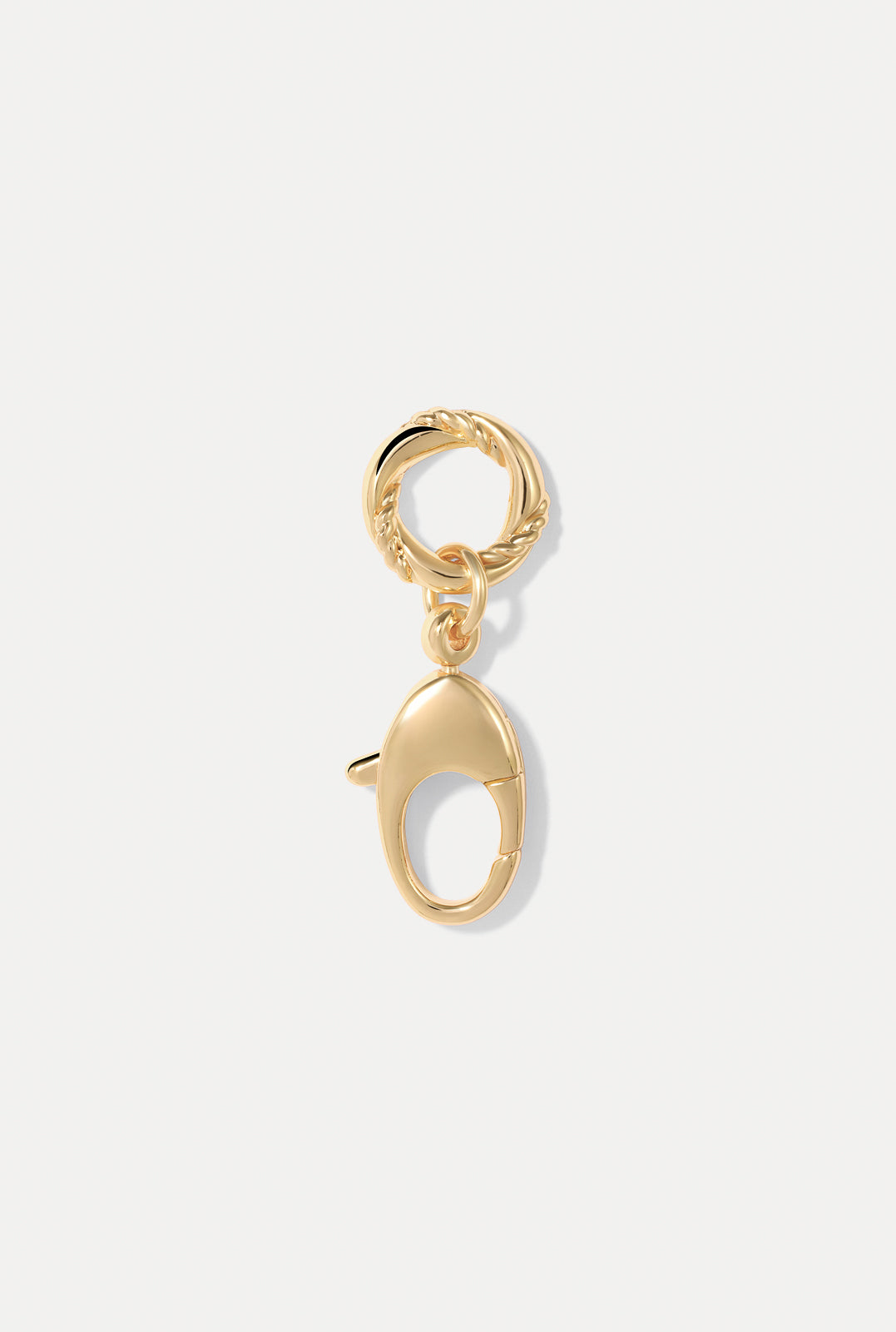 The Sutton Charm in gold pictured on a white background.
