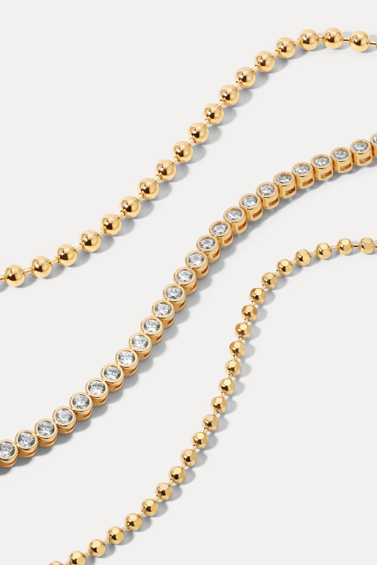 Gold layered classic bracelet stack set displayed against a plain white background.
