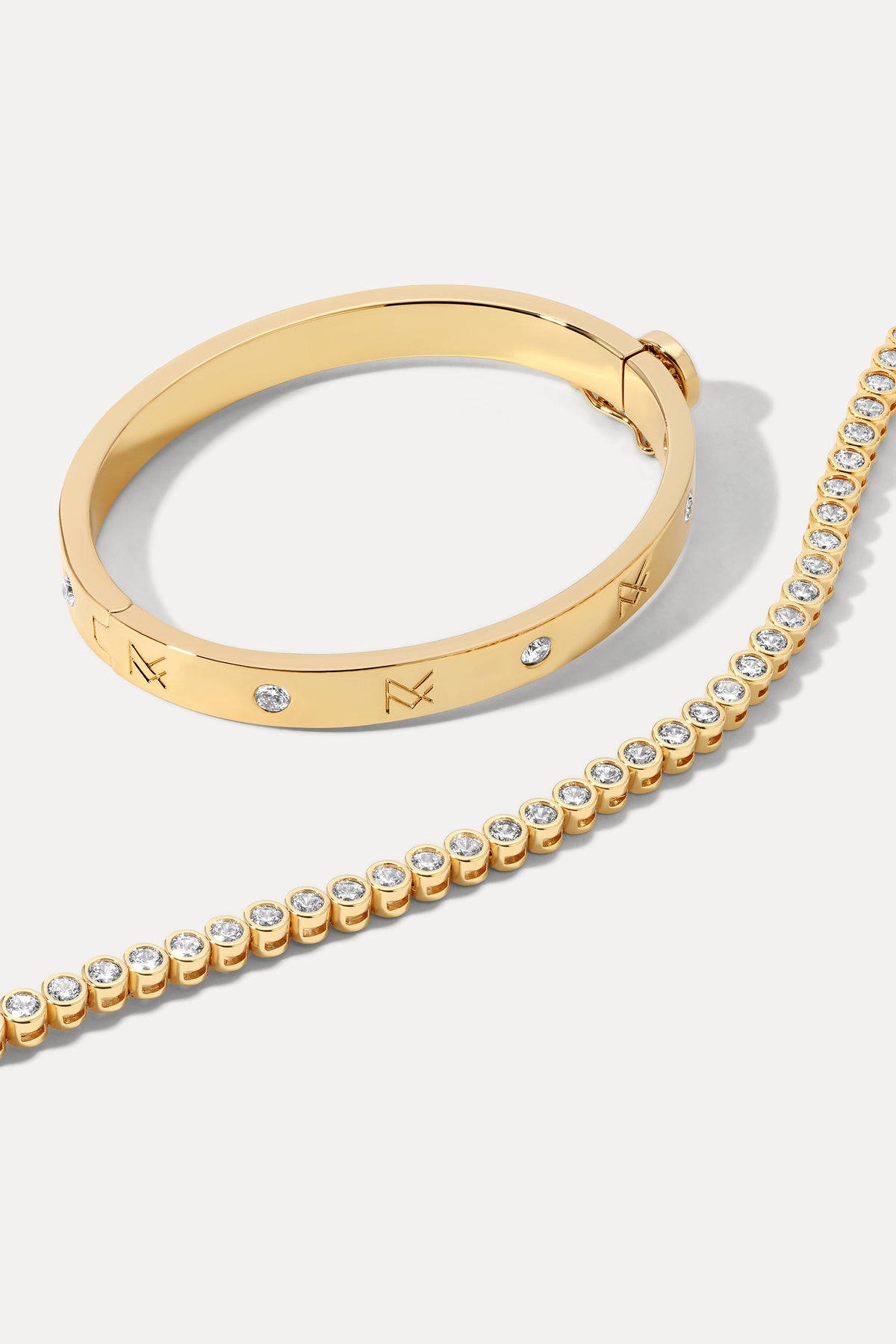 Gold layered bracelet stack displayed on a plain white background.