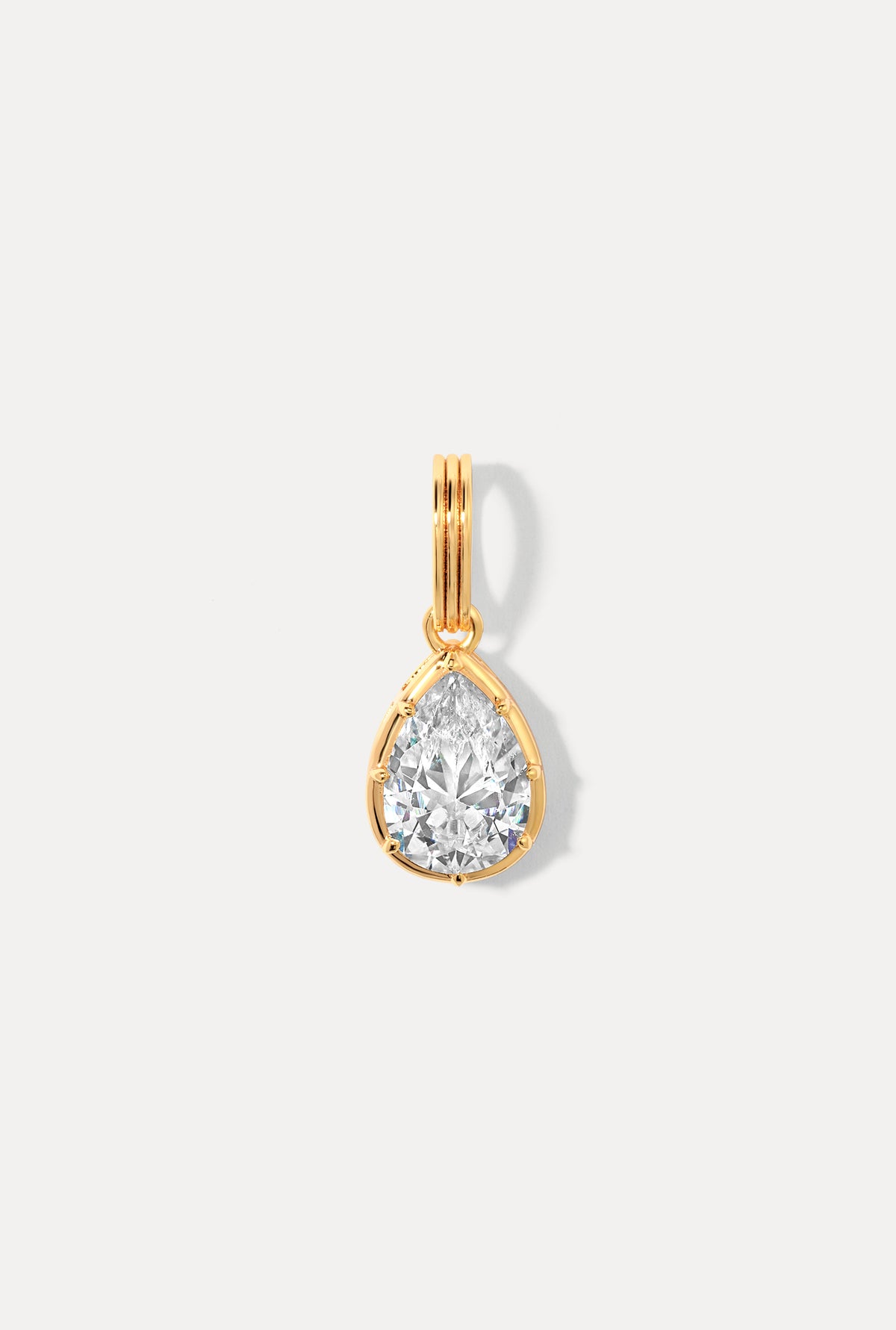 Gold smooth teardrop charm on a ring bail shown against a plain white background.